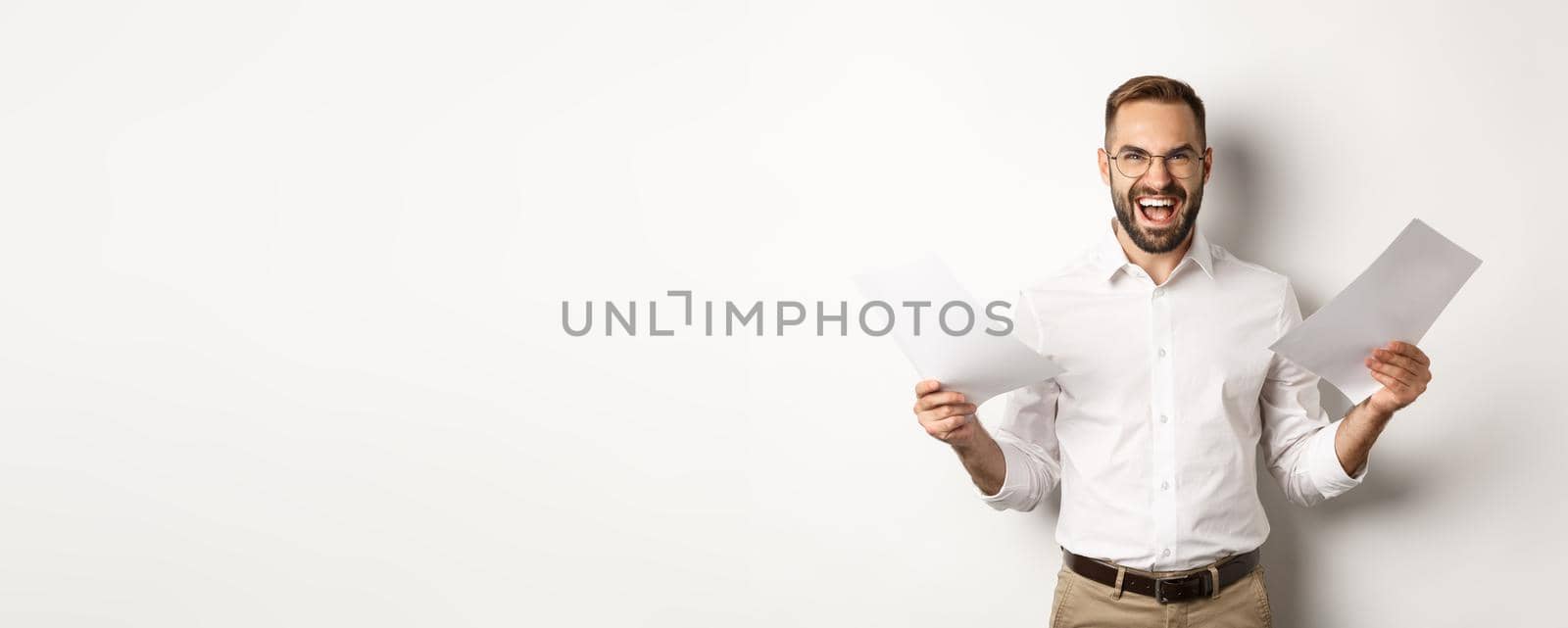 Angry boss disappointed with documents, shouting mad and aggressive, standing over white background by Benzoix
