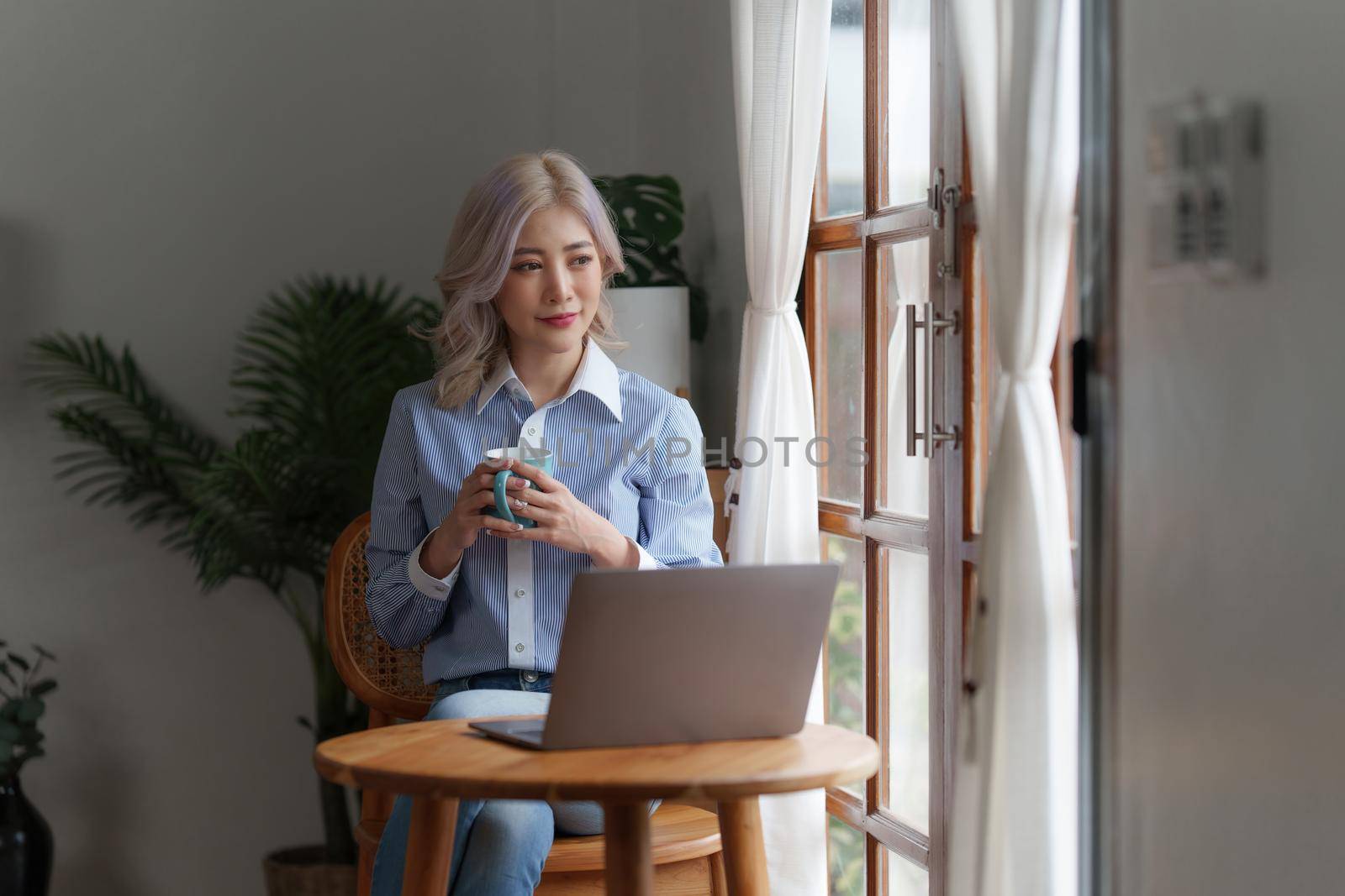 Beautiful woman relaxing and drinking coffee in morning at home