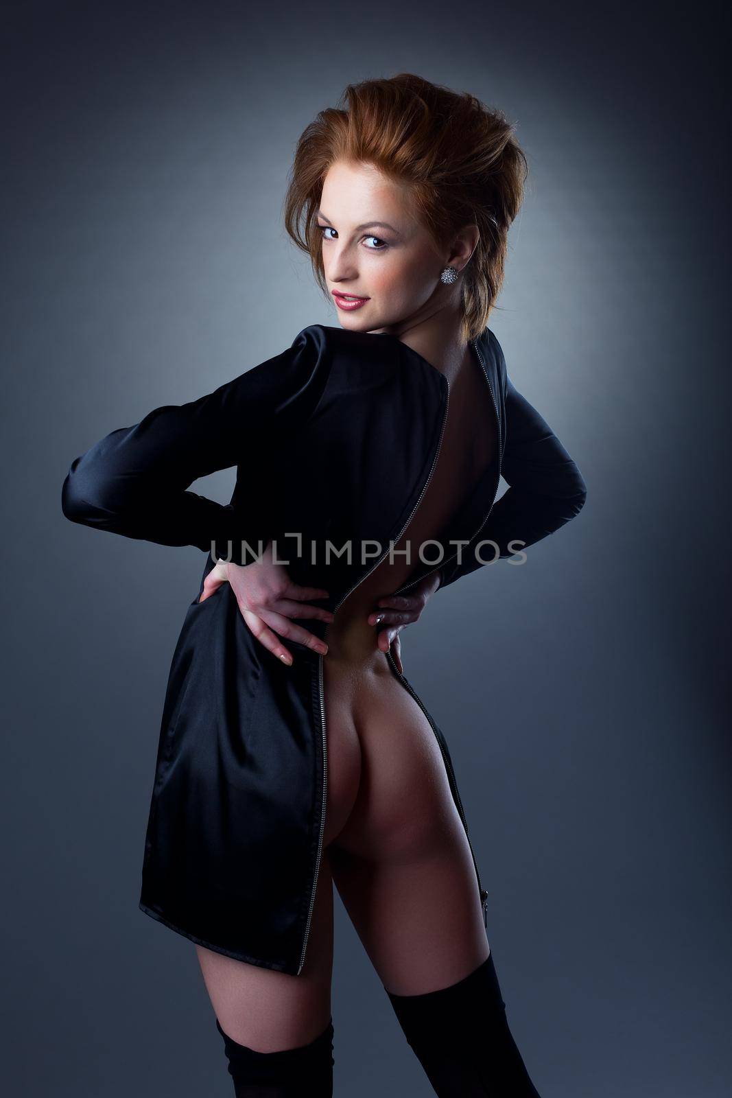 Sexy woman with naked buttocks, undress black suit