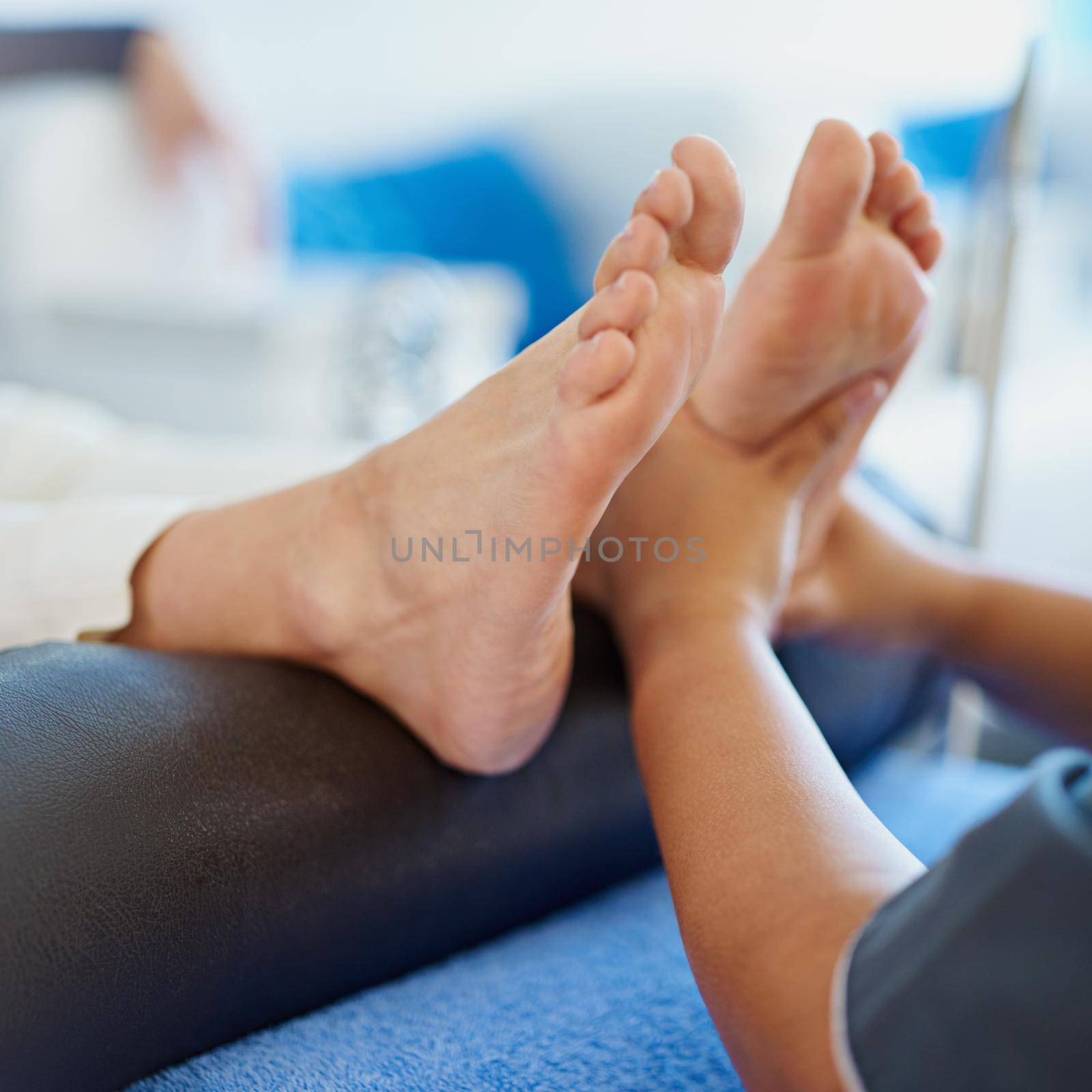 Relaxation from the feet up. a woman having her feet massaged at a beauty spa. by YuriArcurs