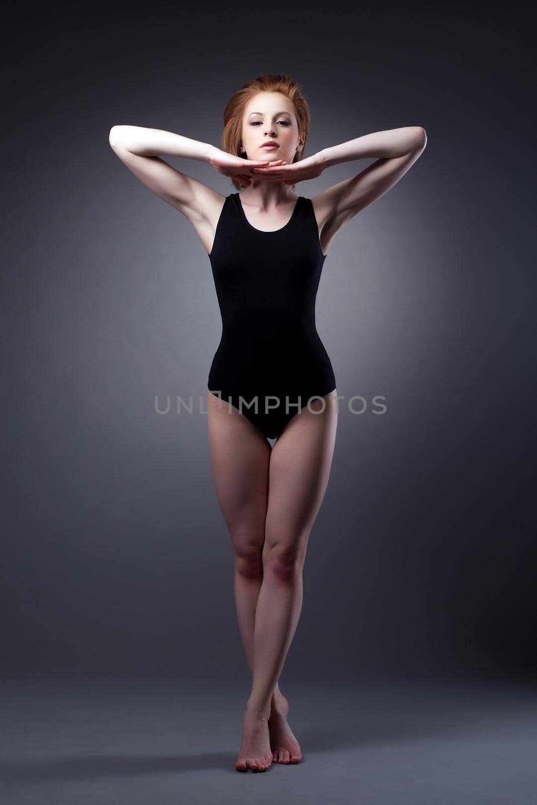 Beautiful young woman stand in sport suit under light