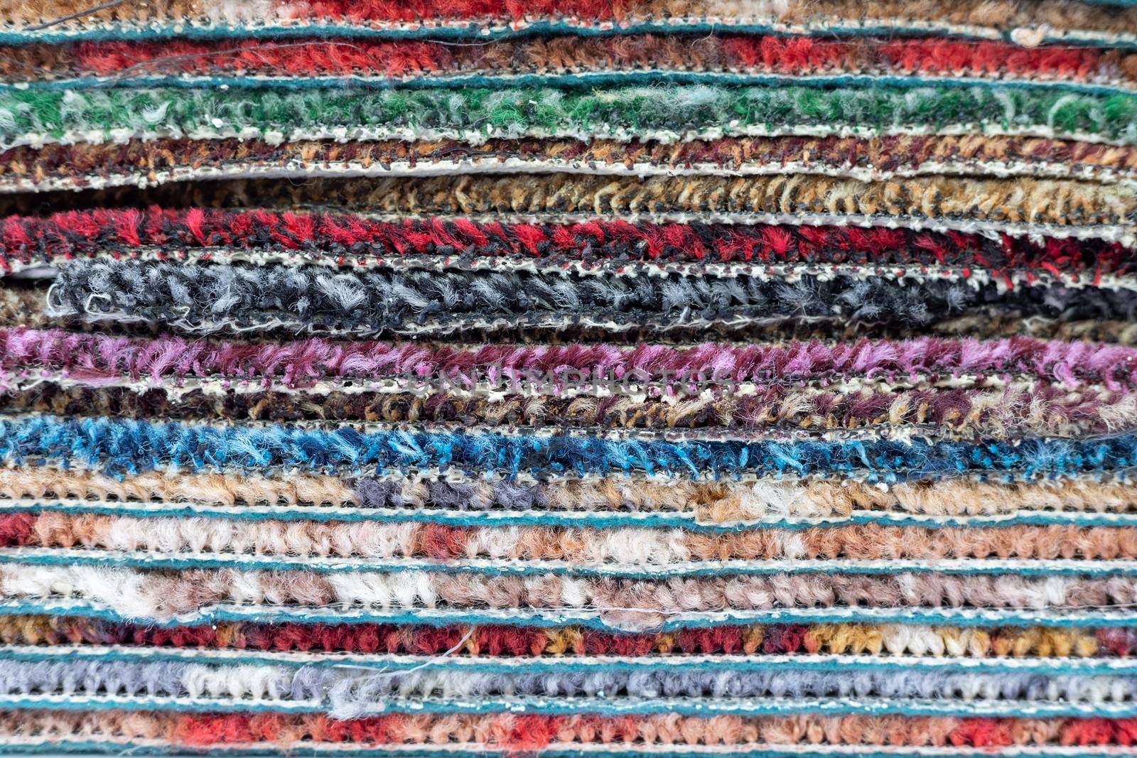 Stack of carpet of multi colors texture background by Bilalphotos