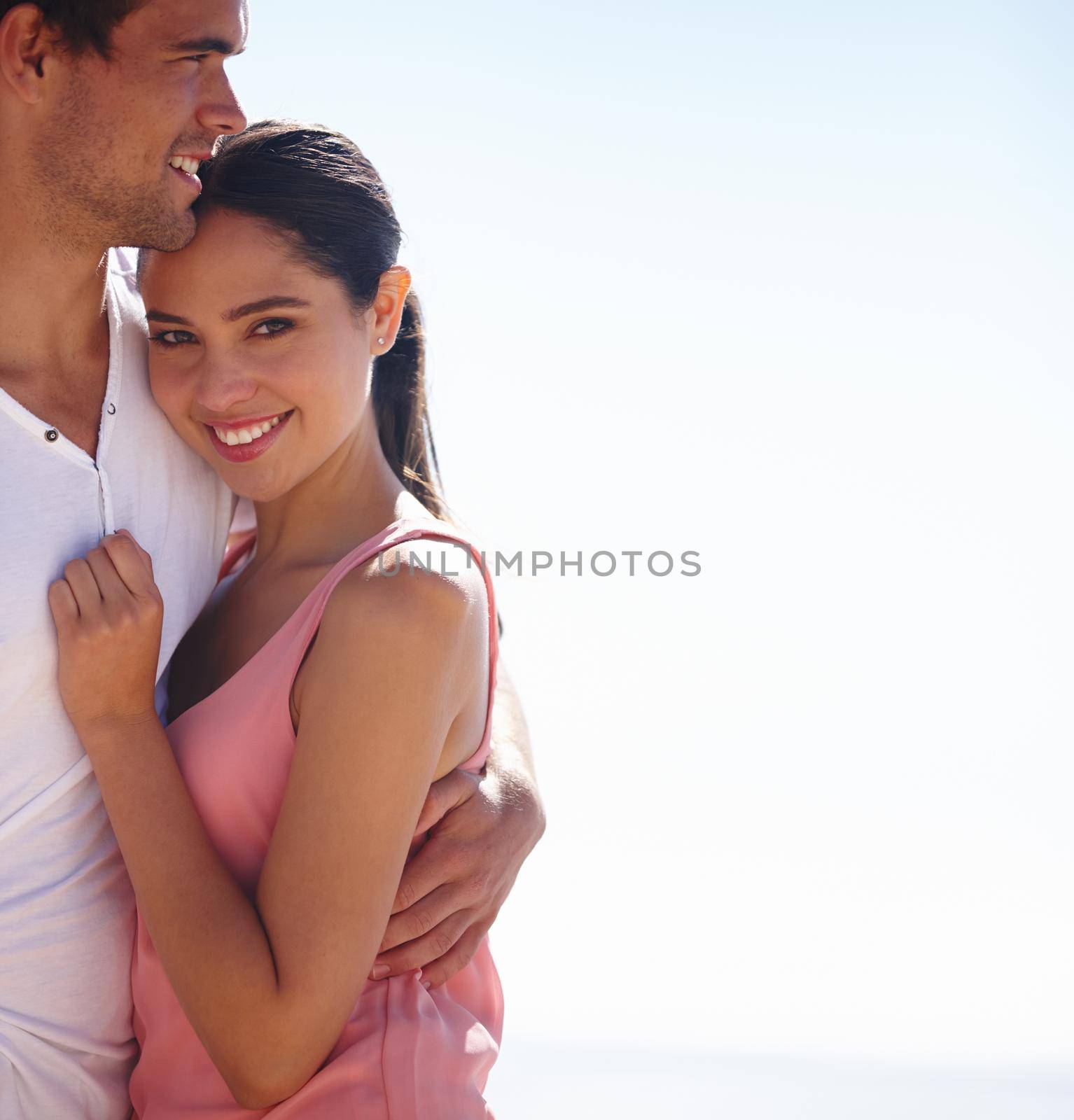 Shes safe and secure in his arms. a young couple outdoors
