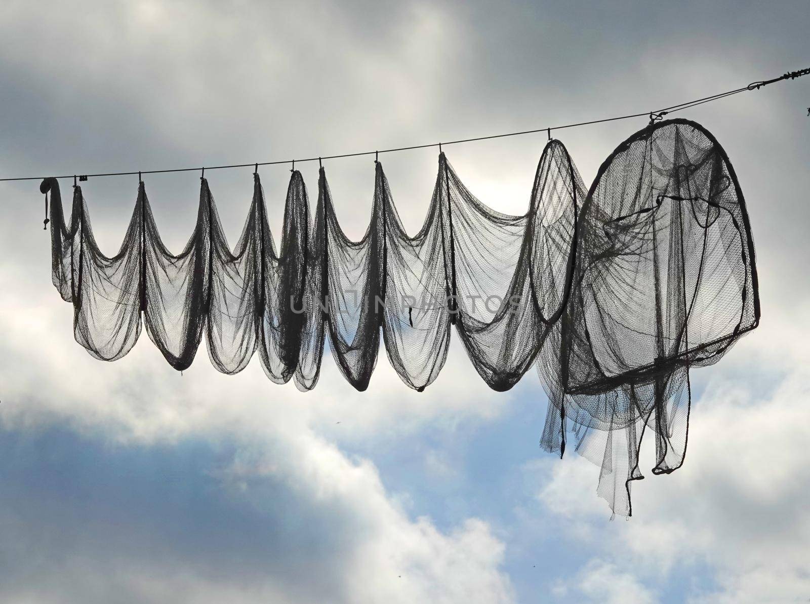 A fishing net  (hoop net or fyke) hanging on a cable. These nets are used in Elburg, the Netherlands, to beautify the main street