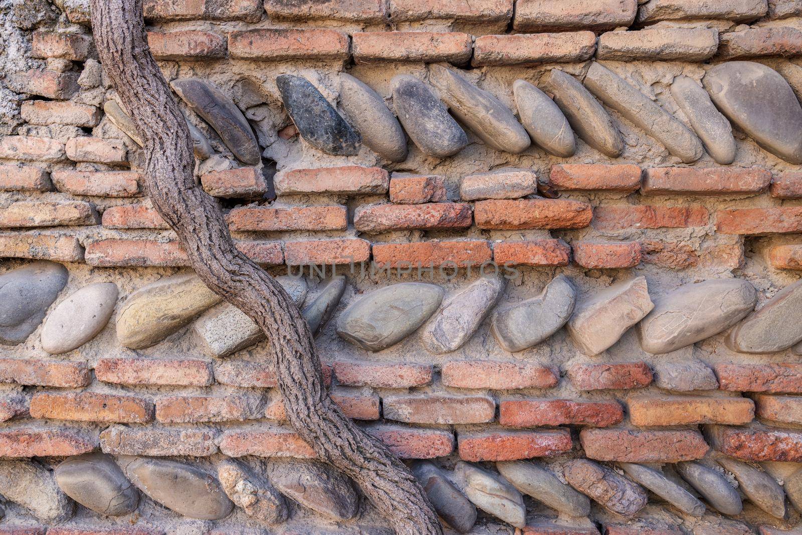 stone background, vintage. Wall of an old house made of stones and bricks by Ramanouskaya