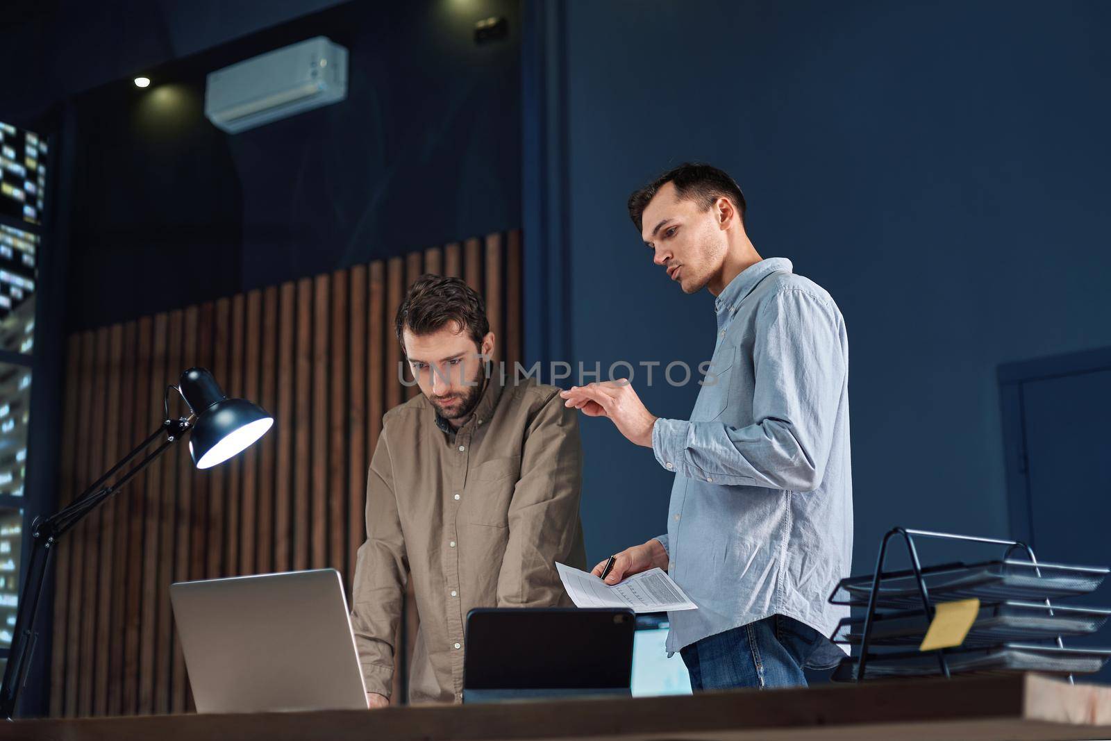 colleagues working working on a new project after hours. by SmartPhotoLab