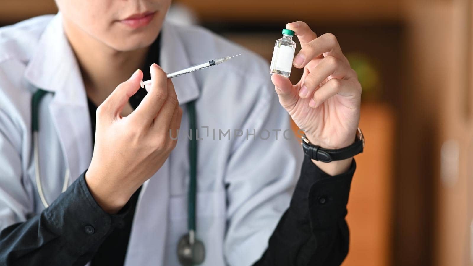Doctor holding vaccine bottle and syringe. Medicine and healthcare concept. by prathanchorruangsak