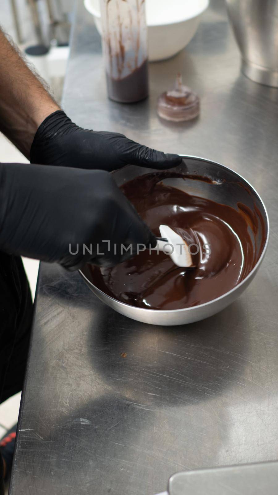 chef making for icing a drip cake in the professional kitchen lab