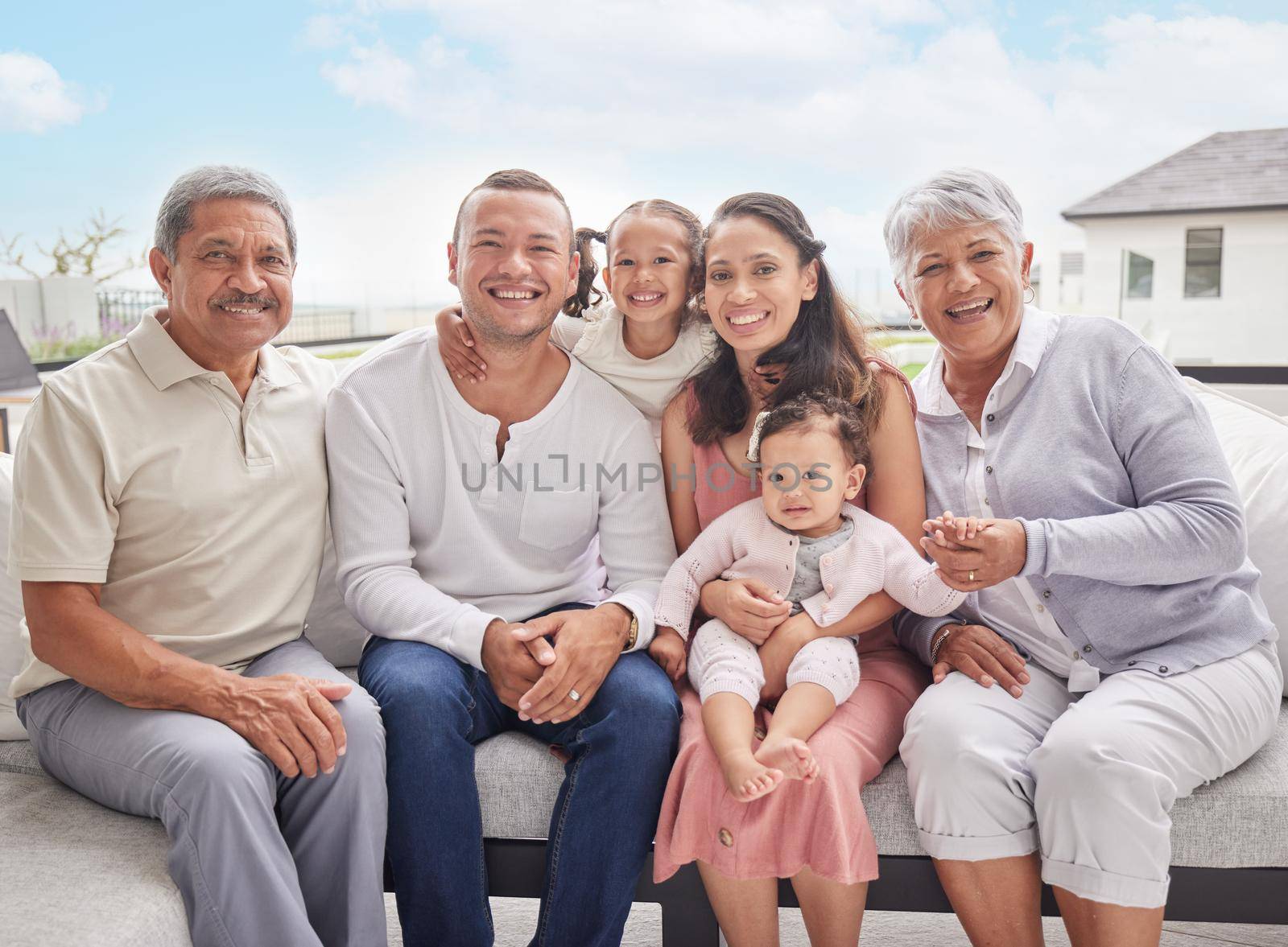 Big family portrait, children with grandparents at summer holiday vacation on sofa with blue sky. Happy Mexico mother, interracial father and kids or baby bonding together on outdoor patio break by YuriArcurs