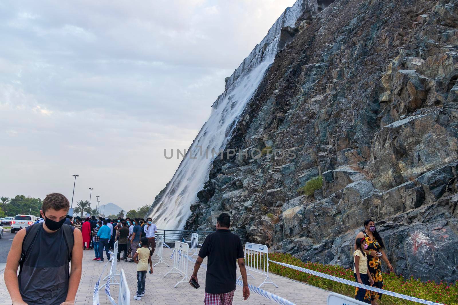 Sharjah, UAE - 07.20.2021 - Visitors at Sharjah amphitheatre waterfall, Khor Fakkan area. Sightseeing by pazemin