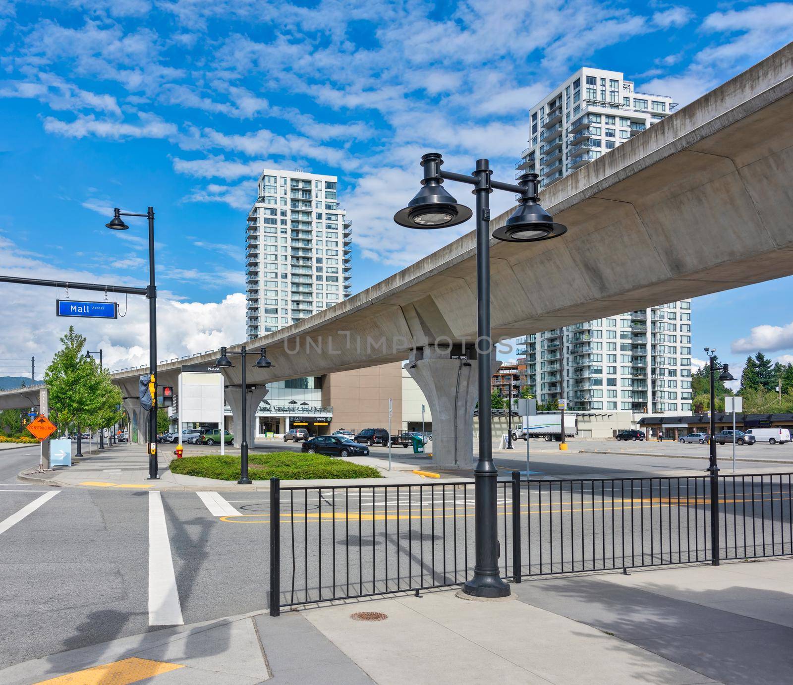 City plaza overview on a bright sunny day. Street view with skytrain line over head