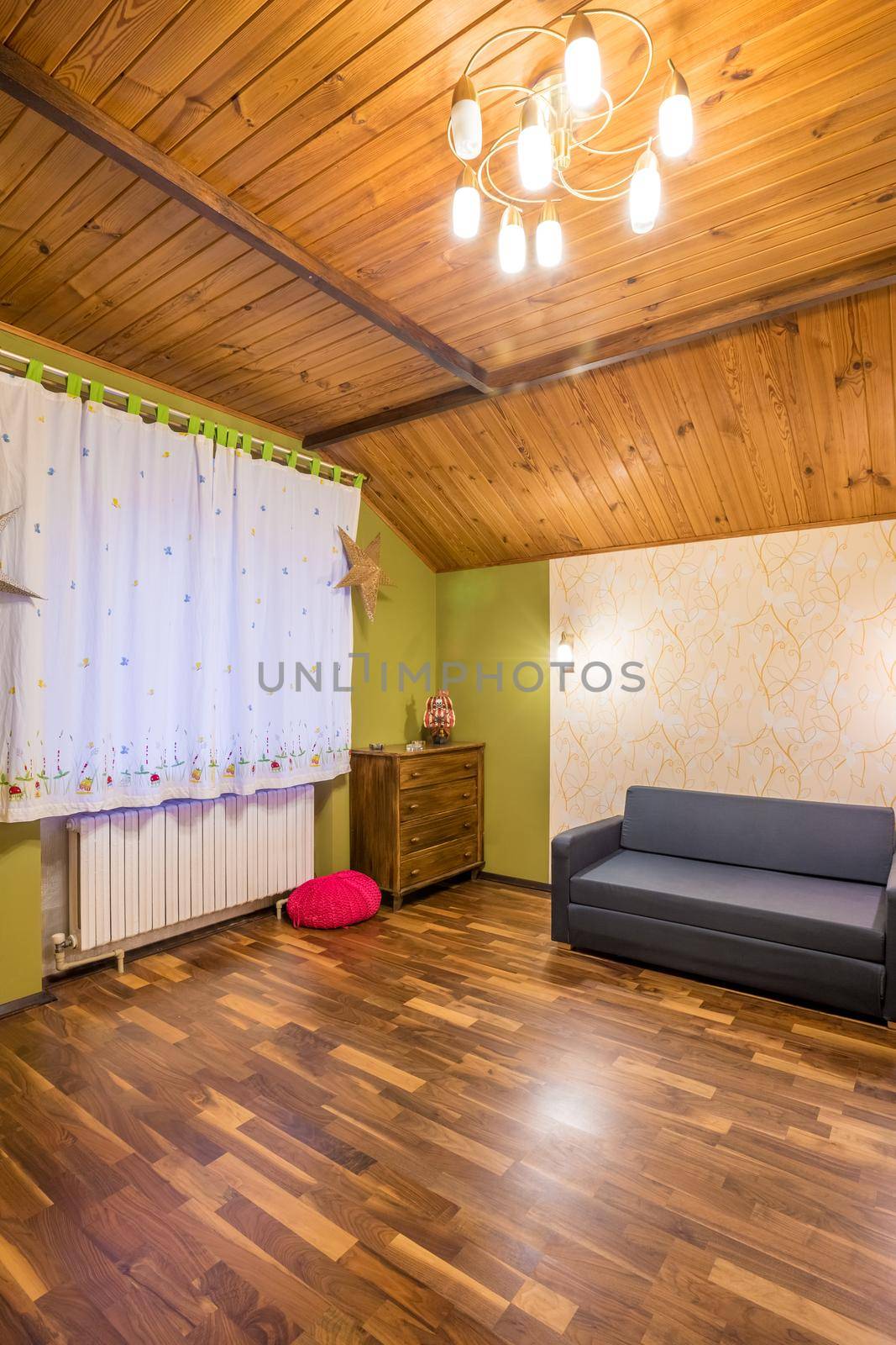 Rooms with a blue sofa, window, chest of drawers, wooden floor. Home