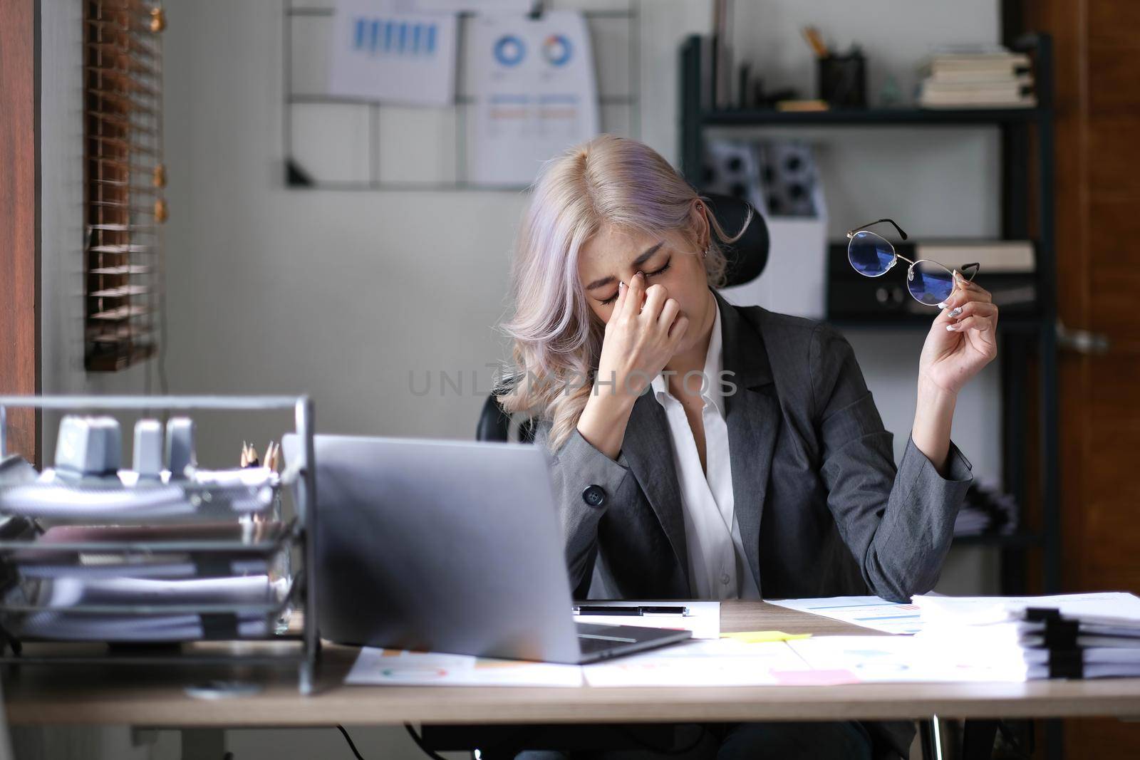 Asian business woman is stressful. bored at work and thinking a lot from unsuccessful work at the office..