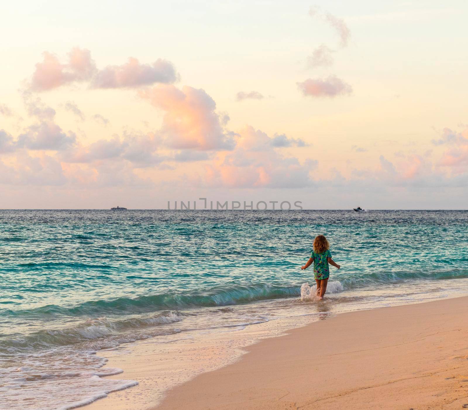 Little girl walking on the beach