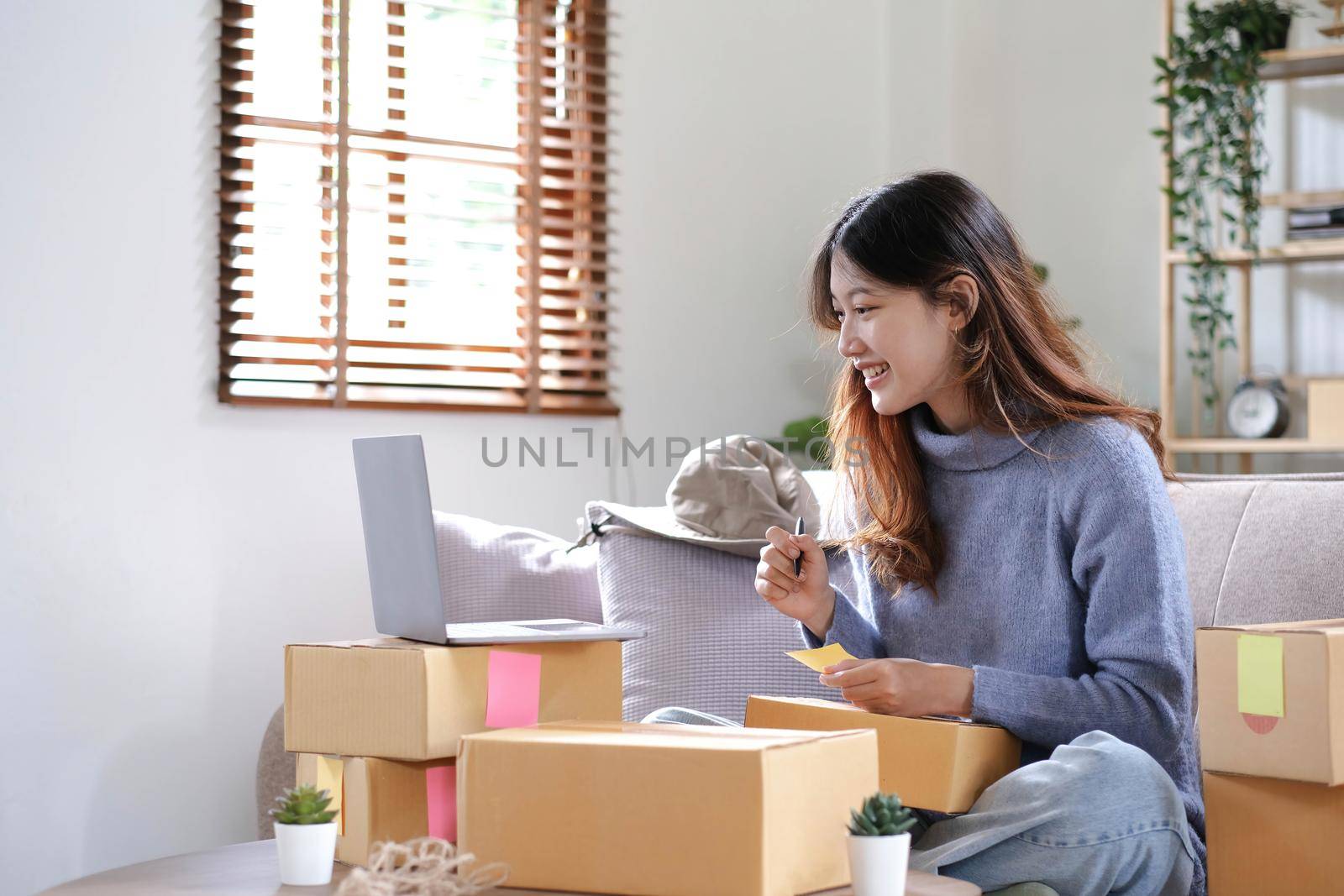 Starting small businesses SME owners female entrepreneurs Write the address on receipt box and check online orders to prepare to pack the boxes, sell to customers, sme business ideas online..