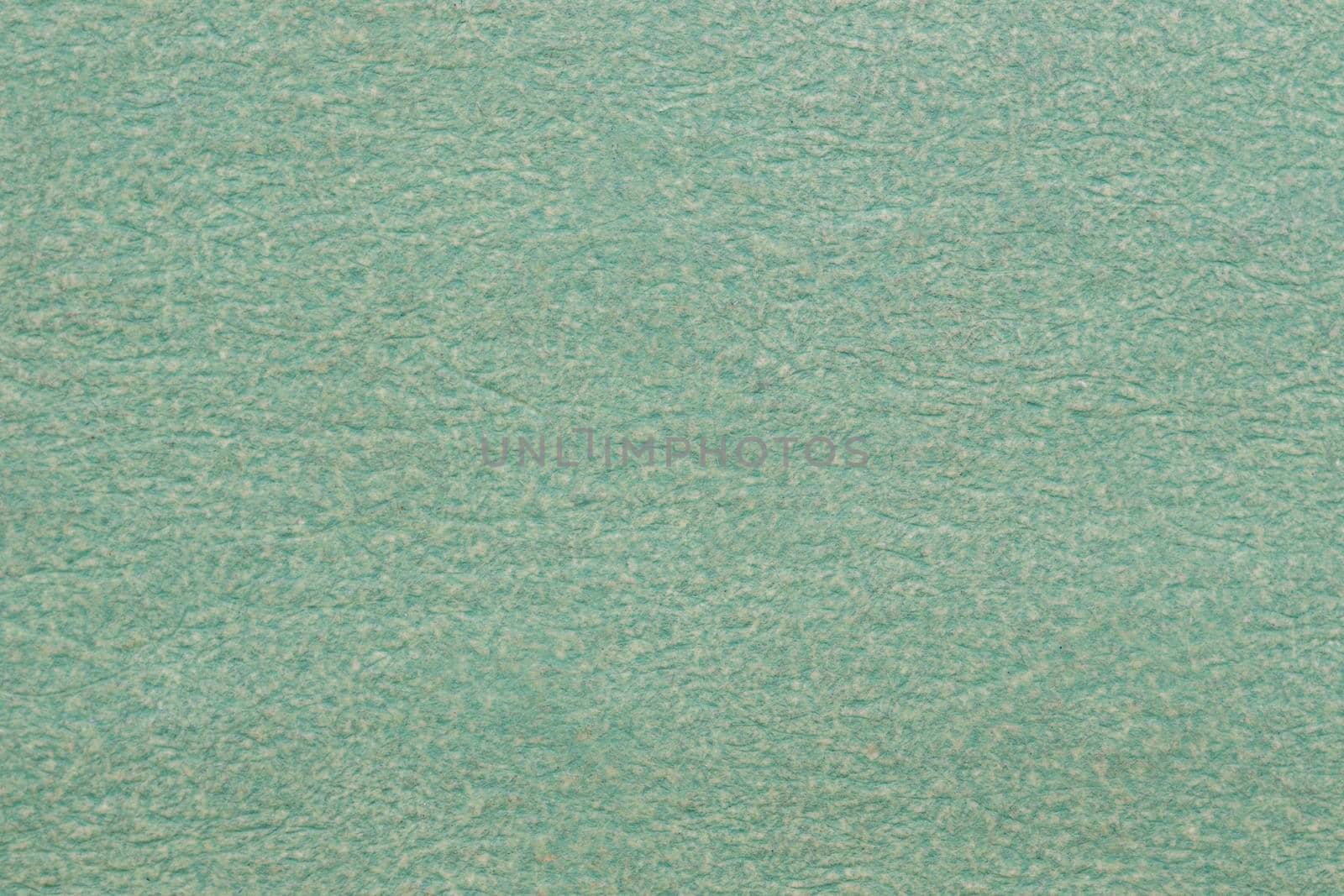 Textured background made of green kraft paper. 