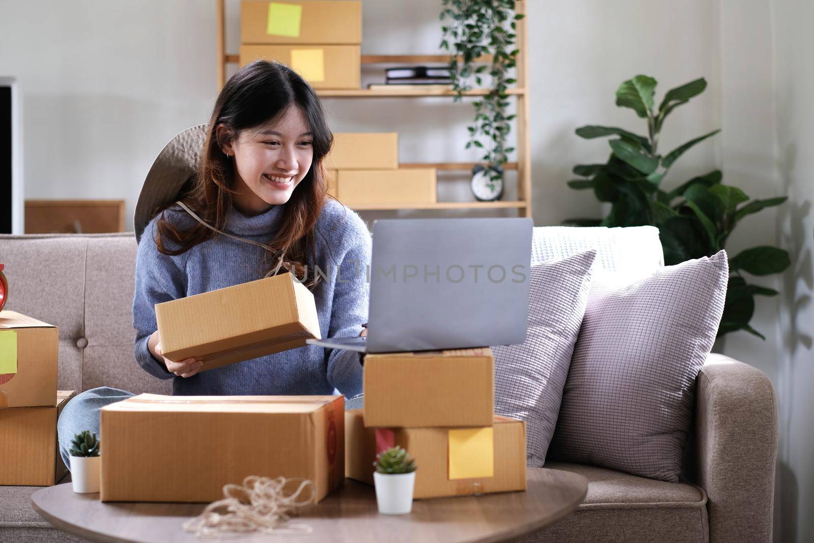 Young woman small business owner working at home office. Online marketing packaging delivery, startup SME entrepreneur or freelance woman concept. Small business owener.