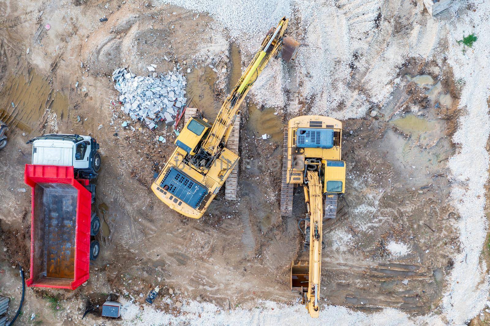 aerial top view of a construction site with heavy machines and truck