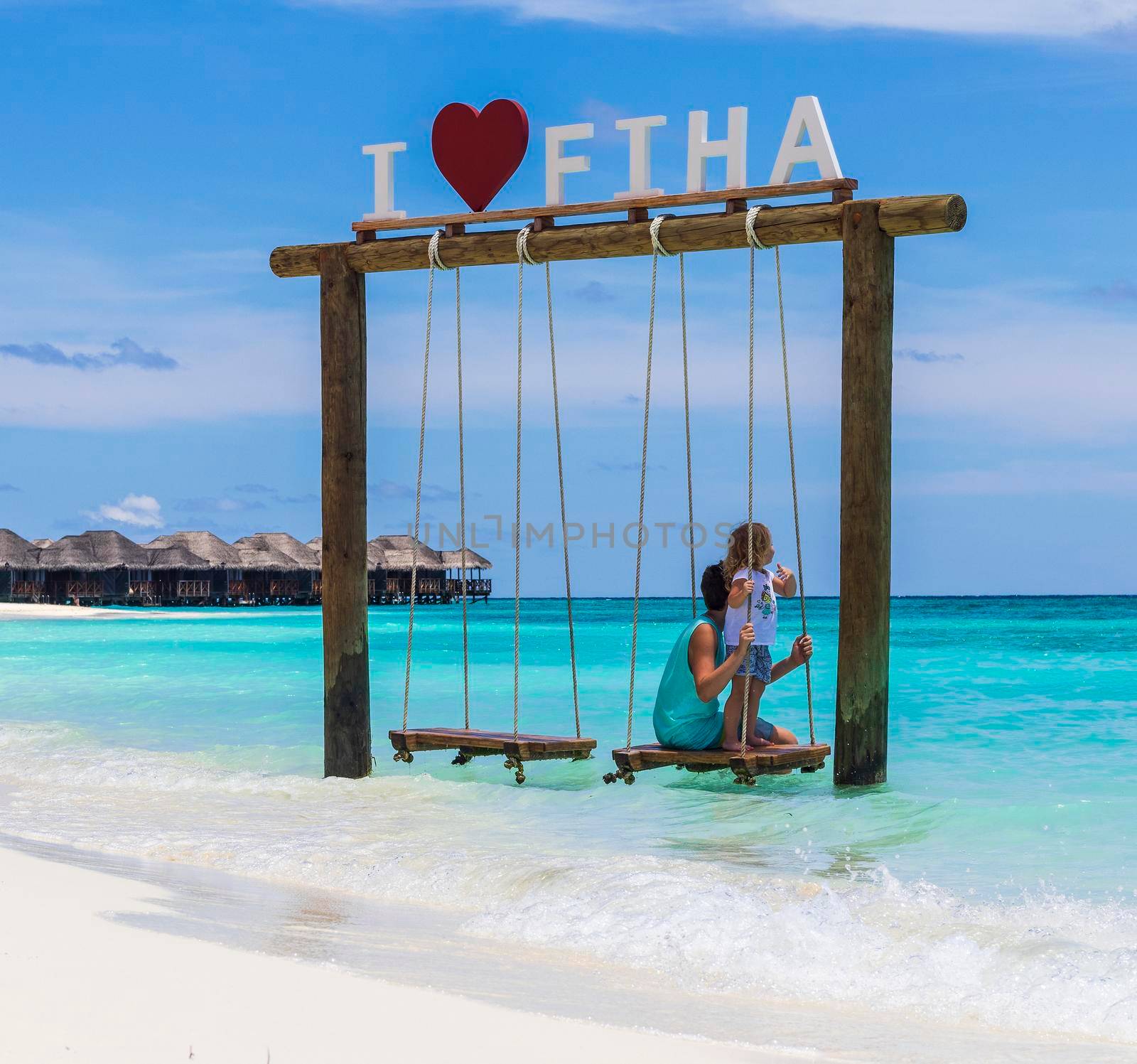 Male, Maldives 04.24.2021 - Kids are playing on the swing at Fihalhohi island resort beach