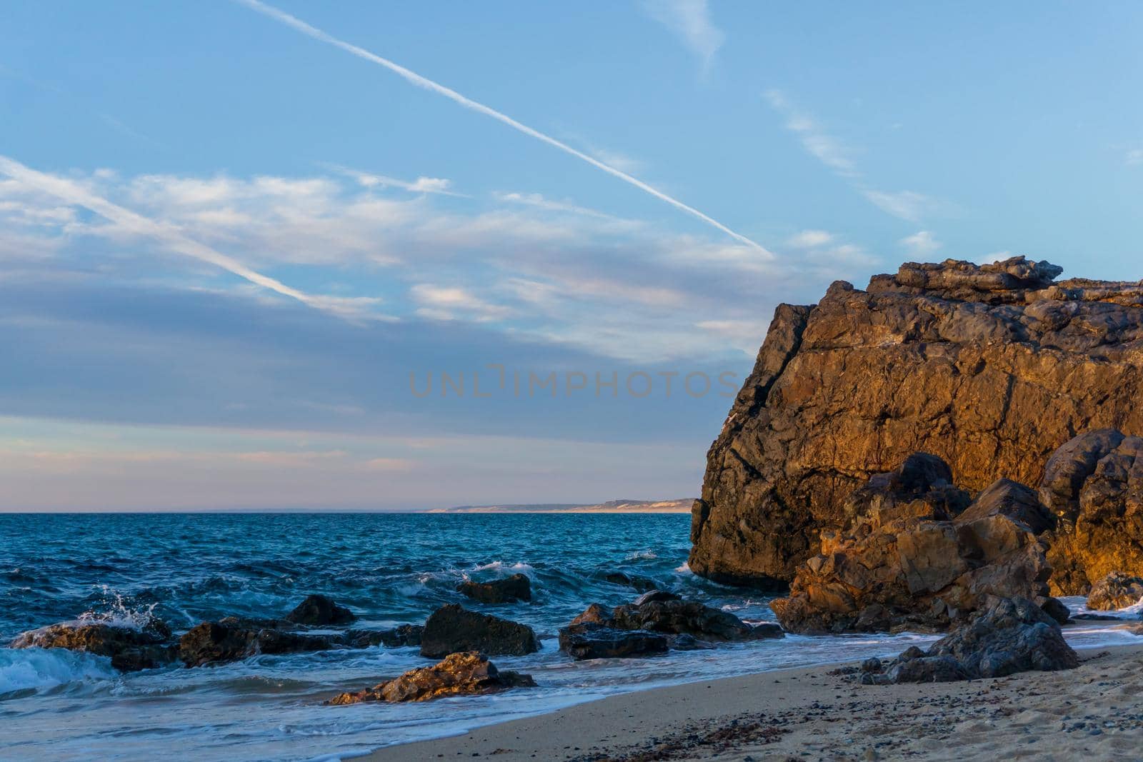 Colorful evening landscape on the beach with rocks background