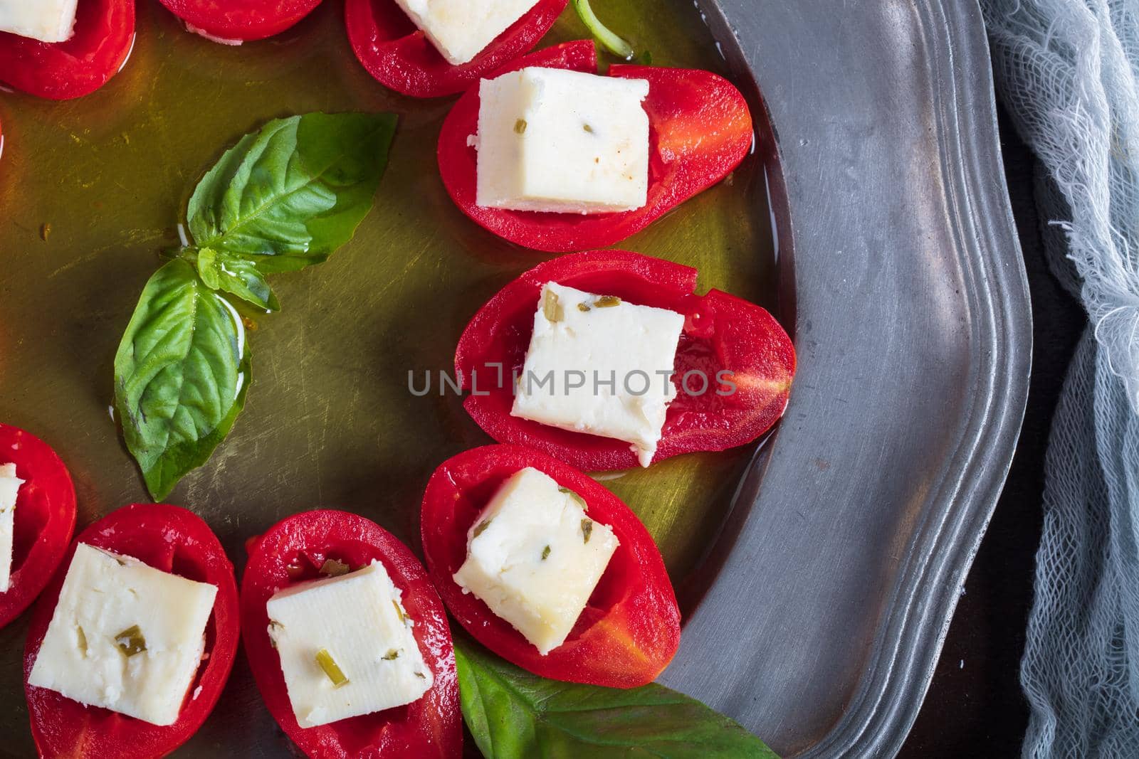 Stuffed tomatoes with cheese and basil . High quality photo