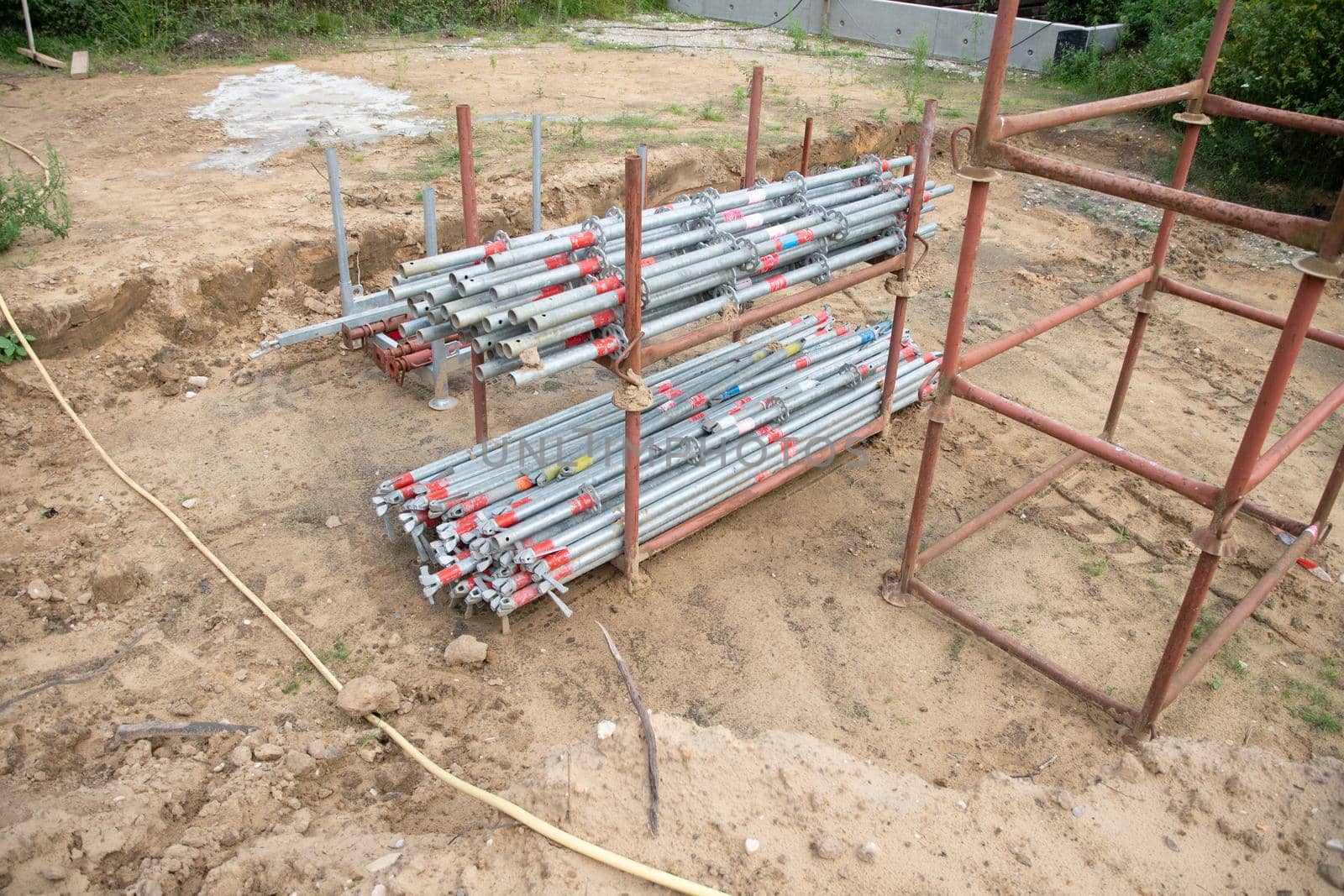 strong metal scaffolding at the construction site of a new house, the beginning of wooden structures around a metal frame. High quality photo
