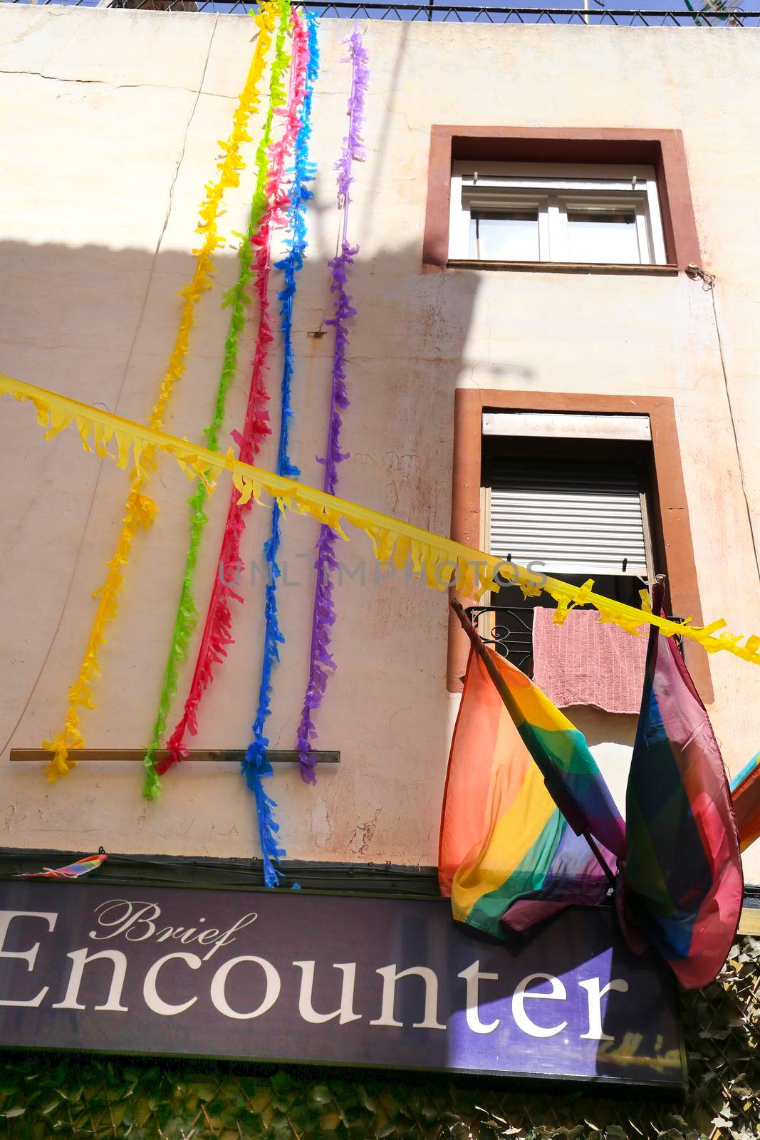 Benidorm, Alicante, Spain- September 10, 2022: Streets and facades adorned with colorful rainbow flags for The Gay Pride in Benidorm