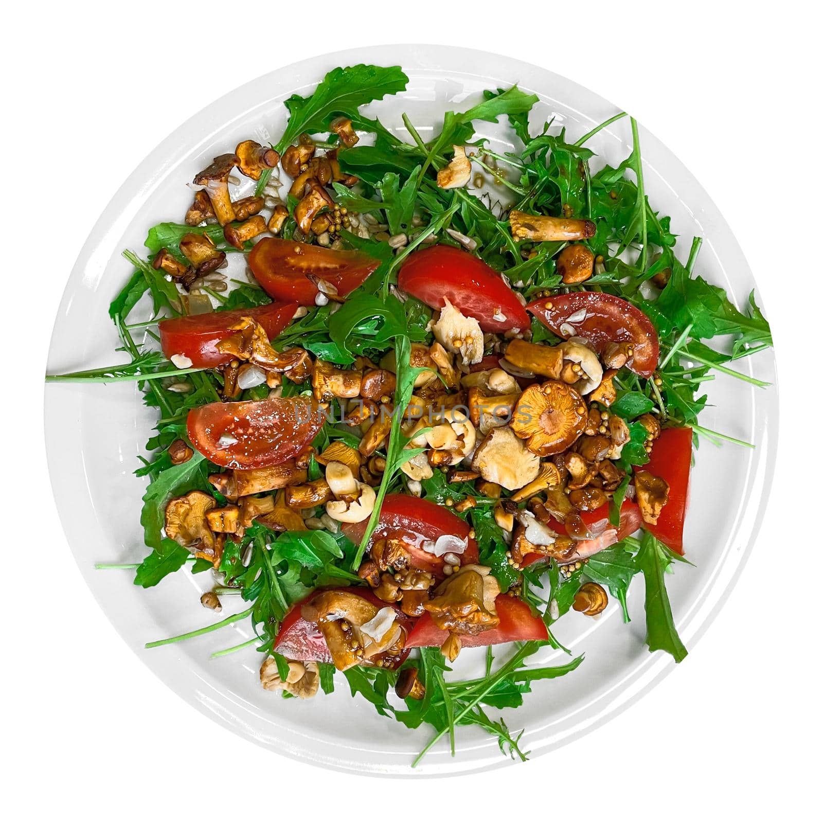 Salad with arugula and chanterelle mushrooms on plate by yganko