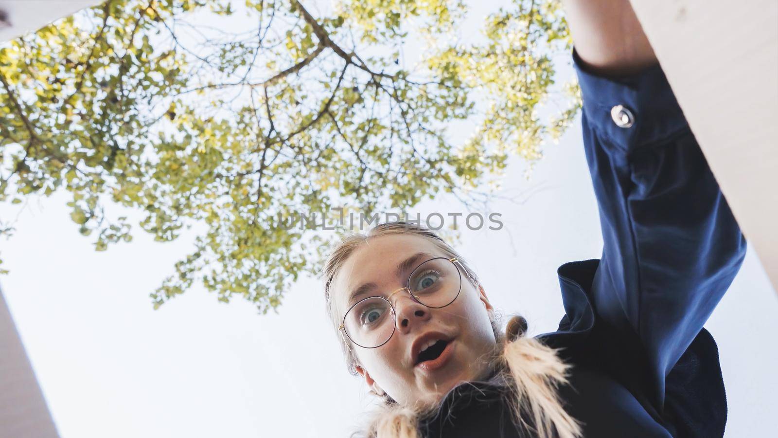 A girl opens a box in the park in admiration