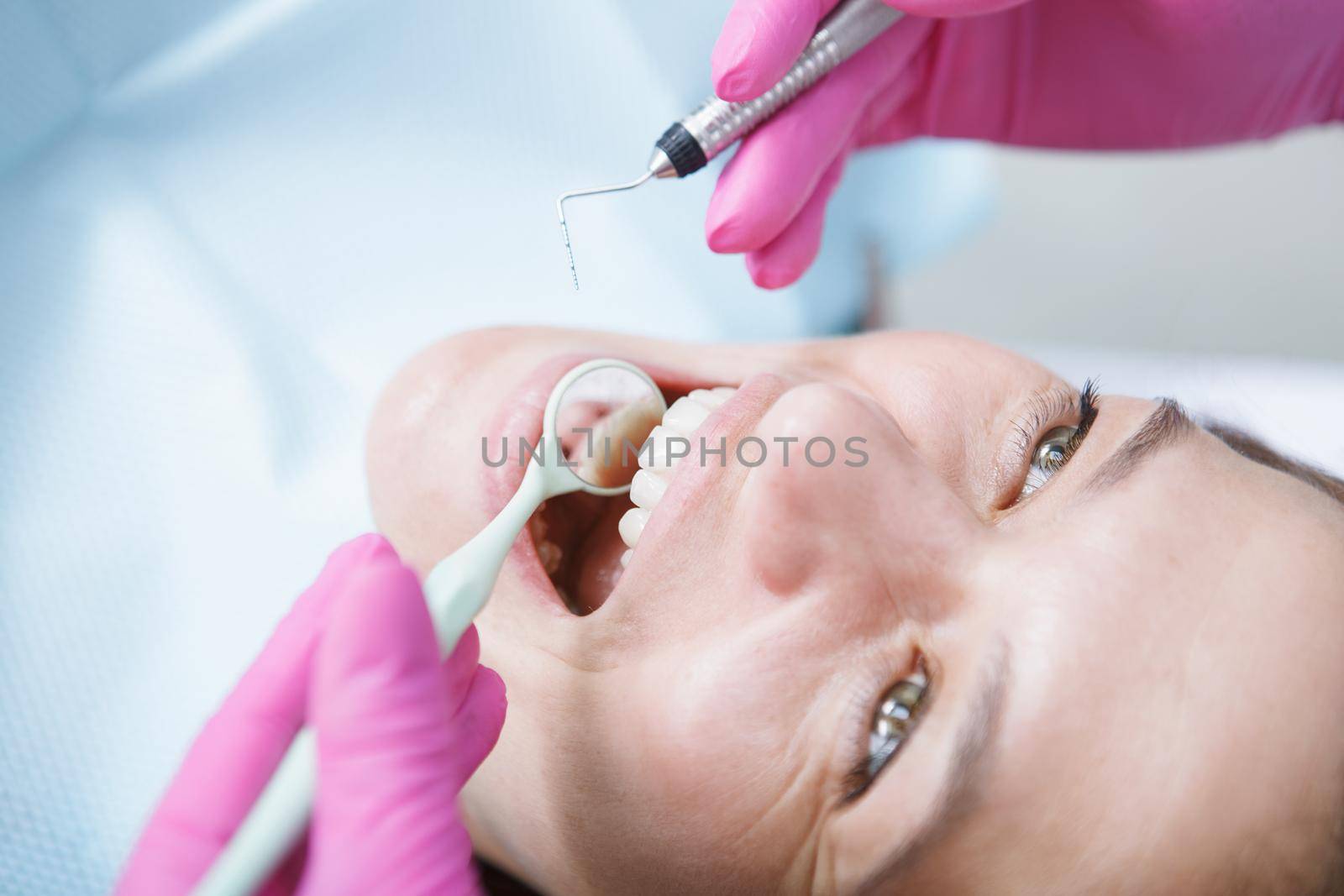 Cropped close up of a female patient having teeth checked by dentist