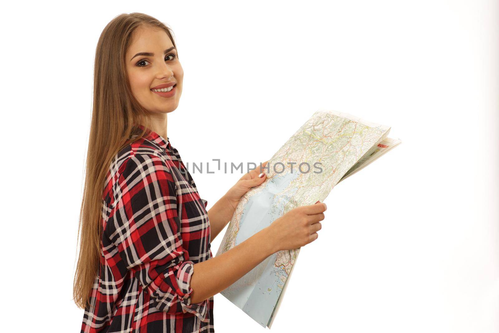 Cheerful young woman using travelling map by MAD_Production