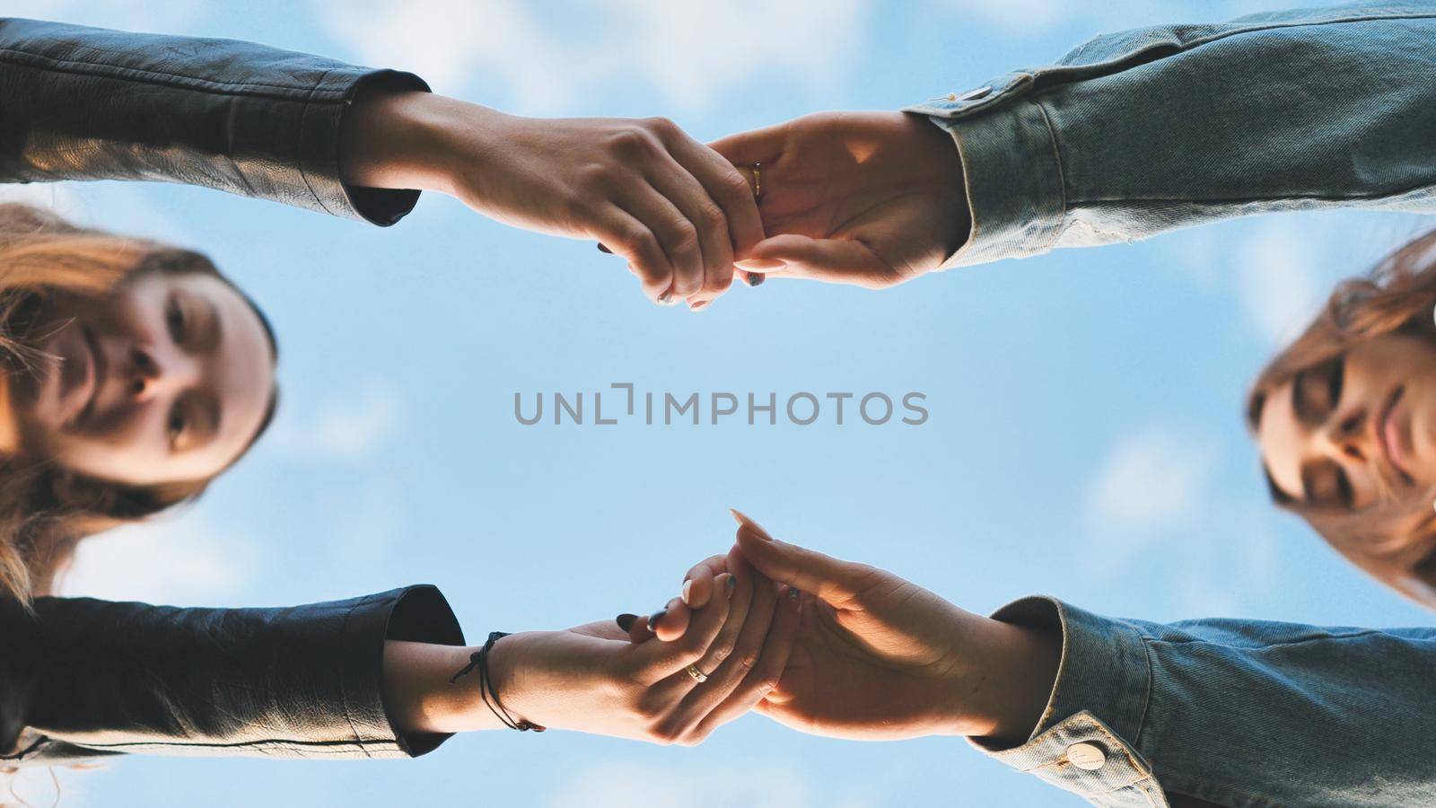 young male couple holding hands standing on their way together by DovidPro