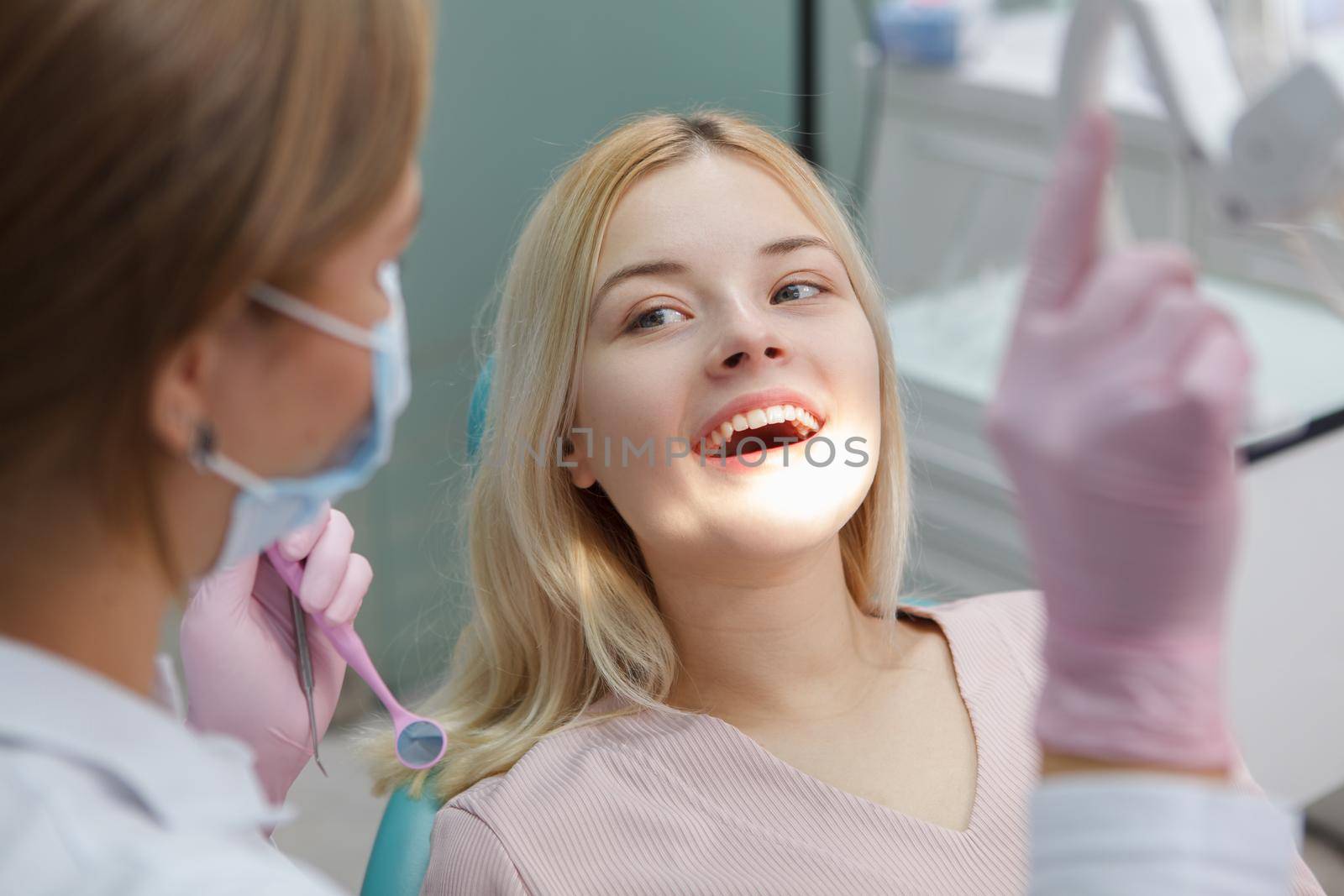 Lovely young woman having dental examination by MAD_Production