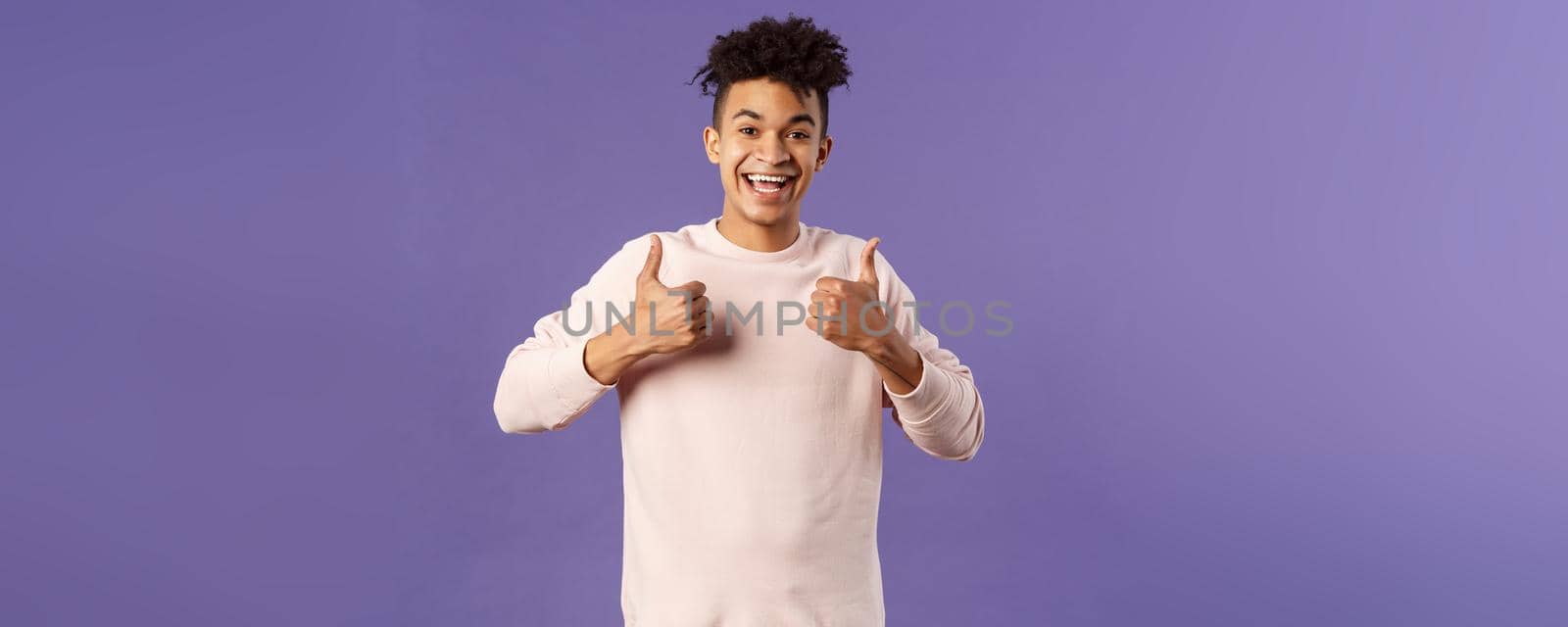 Sounds great, I am in. Portrait of joyful, smiling young hispanic hipster guy with afro haircut, recommend product, left pleased after watching awesome performance, show like approve sign by Benzoix