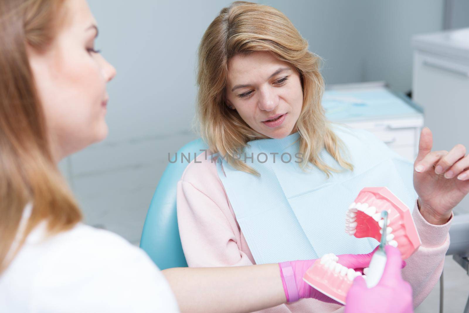 Mature woman talking to her female dentist