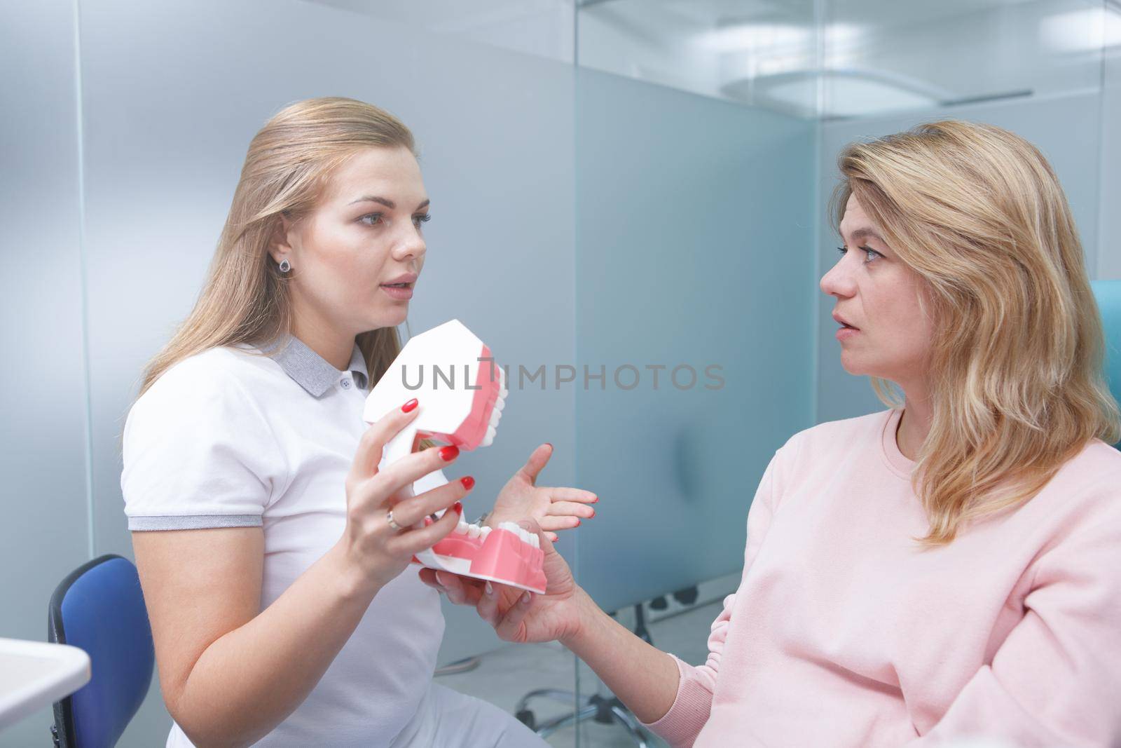 Mature woman getting dental consultation at dentists office