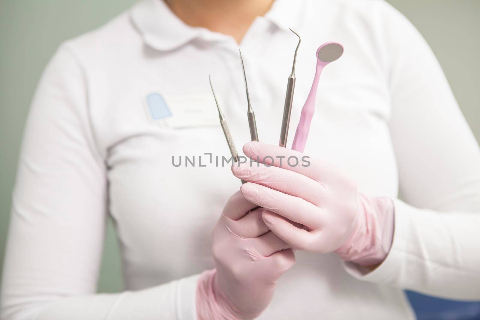 Dental tools in the hands of female dentist