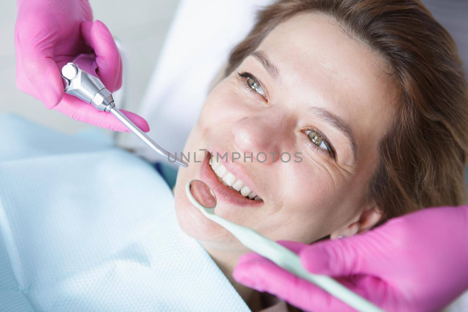 Close up of a cheerful mature woman smiling during dental checkup at the clinic