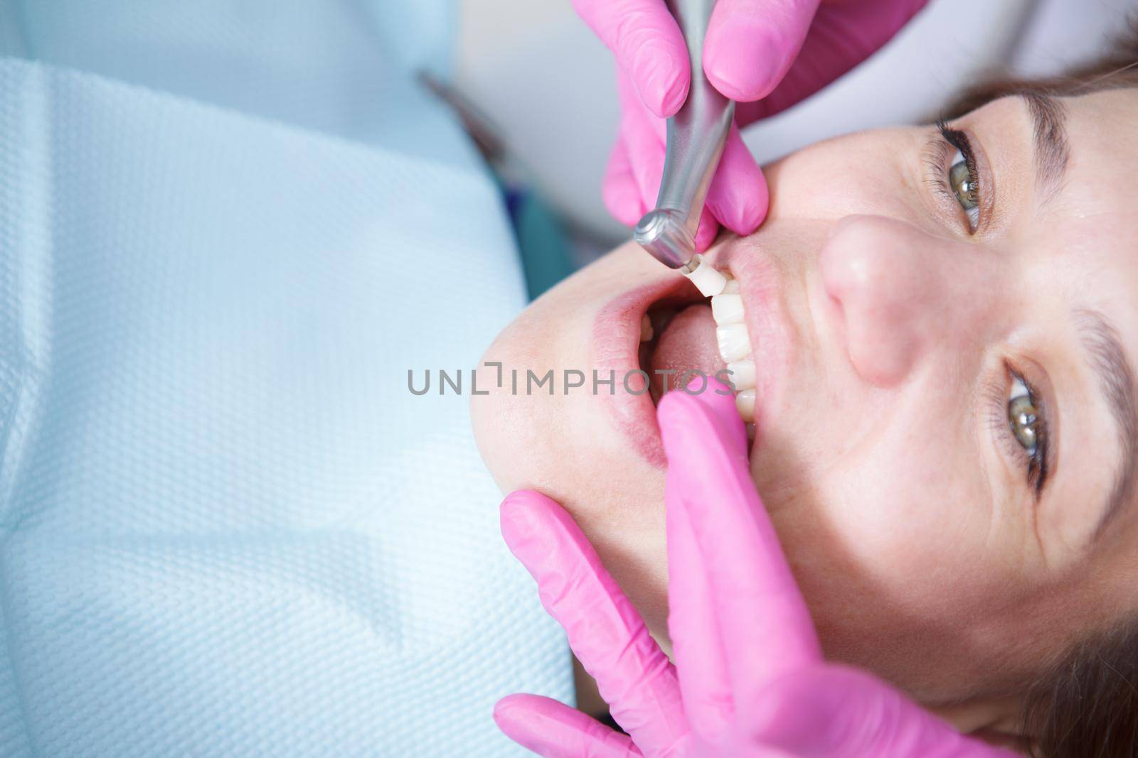 Cropped close up of a mature woman having her teeth cleaned professionally by her dentist