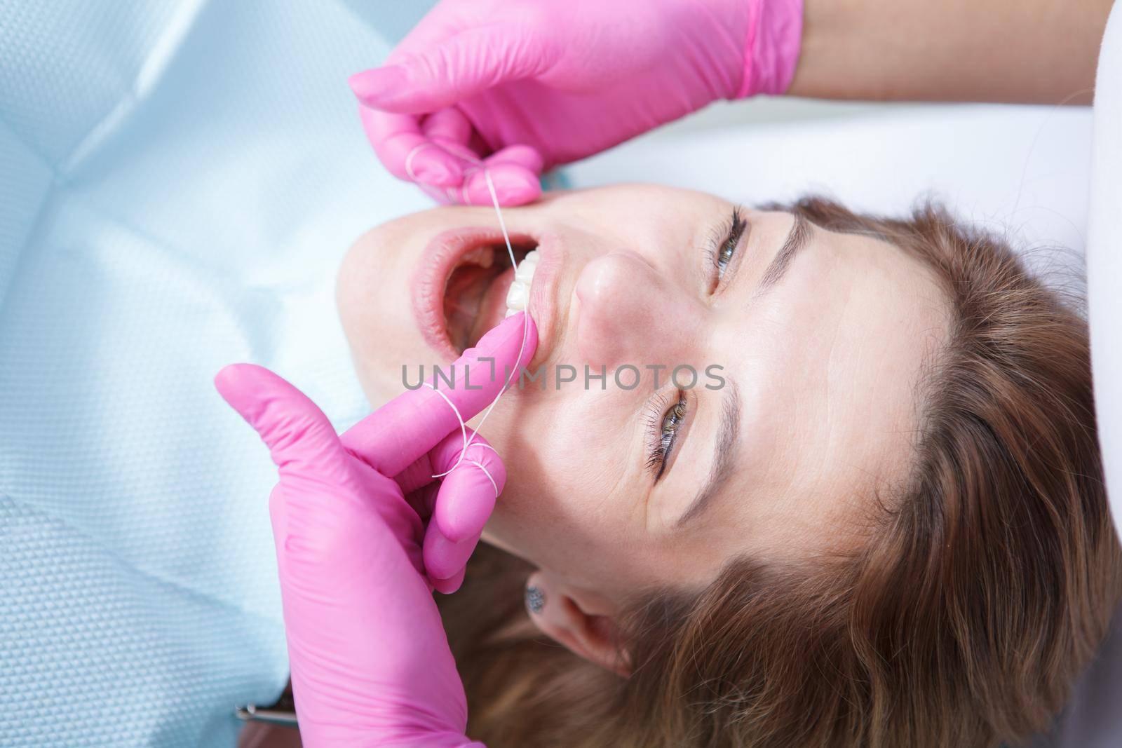 Mature woman at dental clinic by MAD_Production