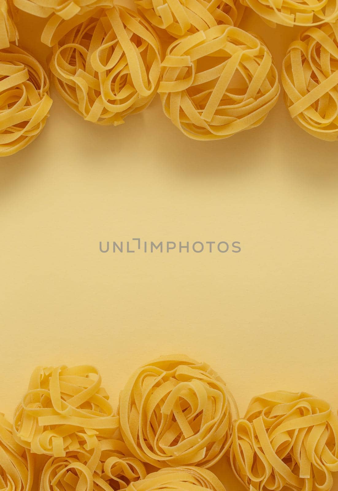 Minimal food pattern of pasta tagliatelle, light yellow pastel background with space for text. Traditional Italian pasta in pop art style, Italian cuisine concept. Top view, flat lay, copy space