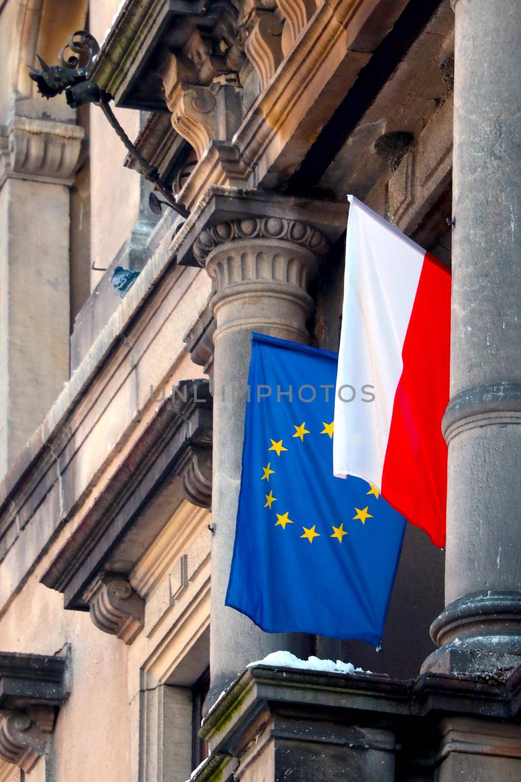 The flags of Poland and the European Union are hung on the building