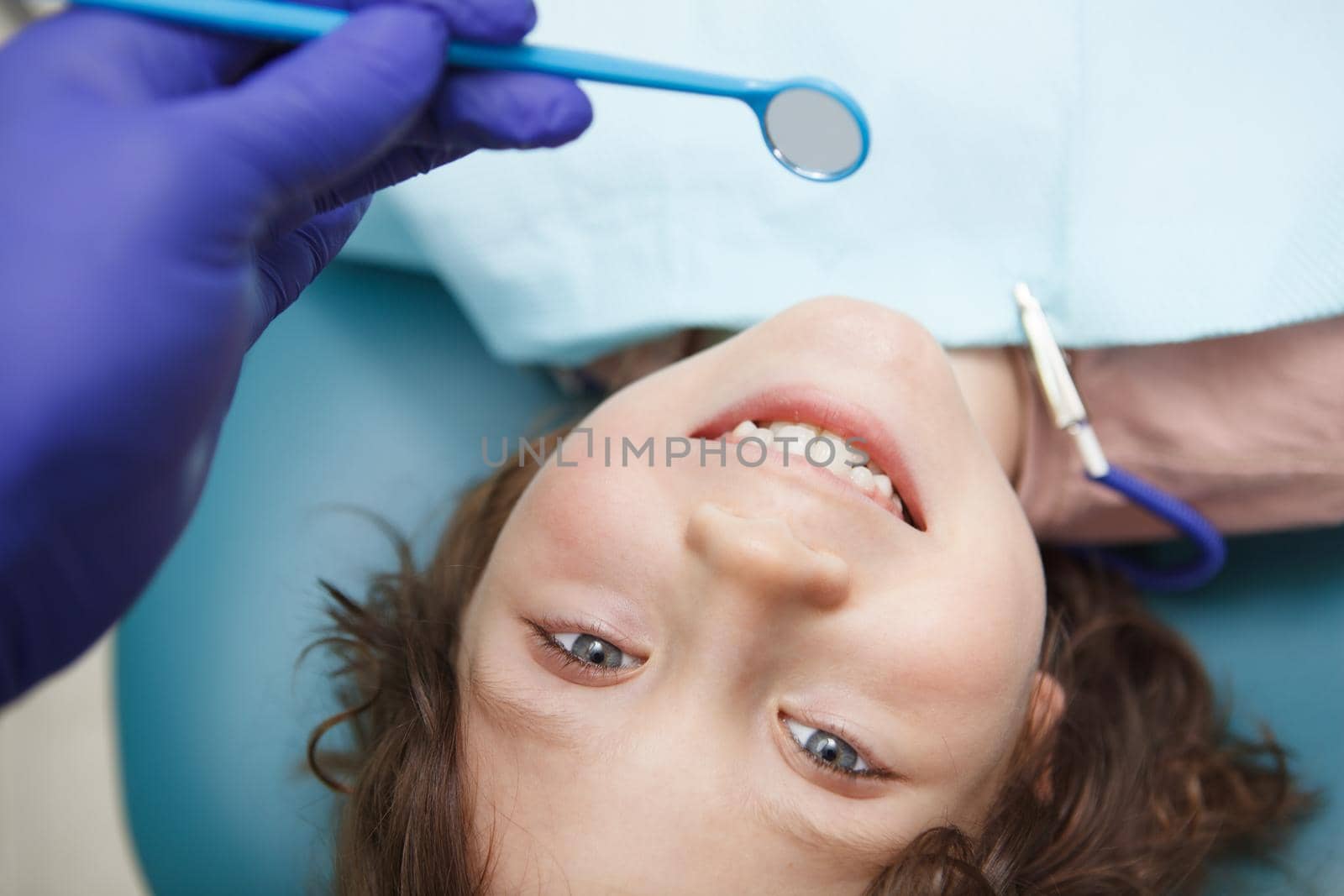 Cropped close up of a happy young boy smiling during dental examination