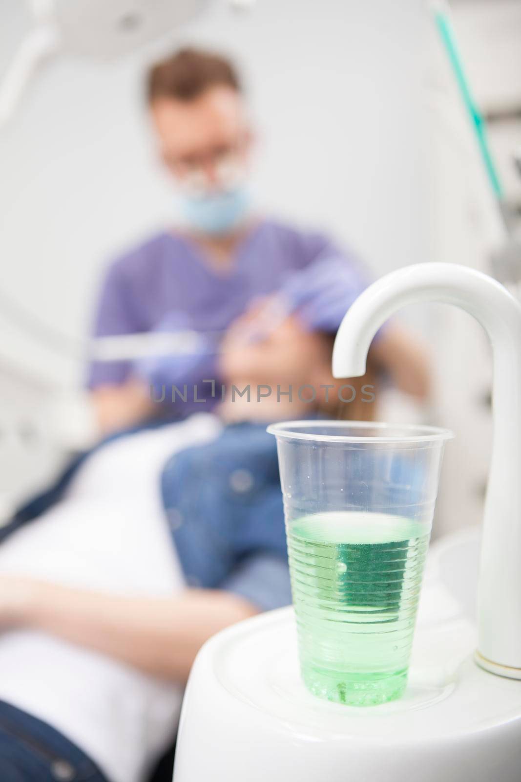 Dentist working with patient at his clinic by MAD_Production