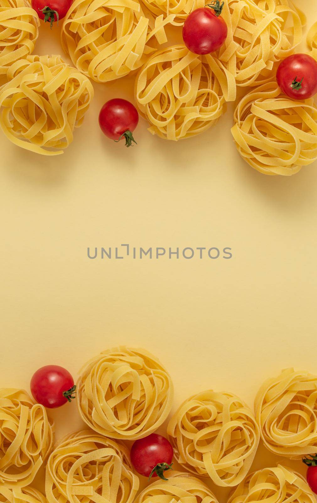 Minimal food pattern tagliatelle and tomatoes, light yellow pastel background. Traditional Italian pasta in pop art style. Pasta and tomatoes, Italian cuisine concept. Top view, flat lay, copy space