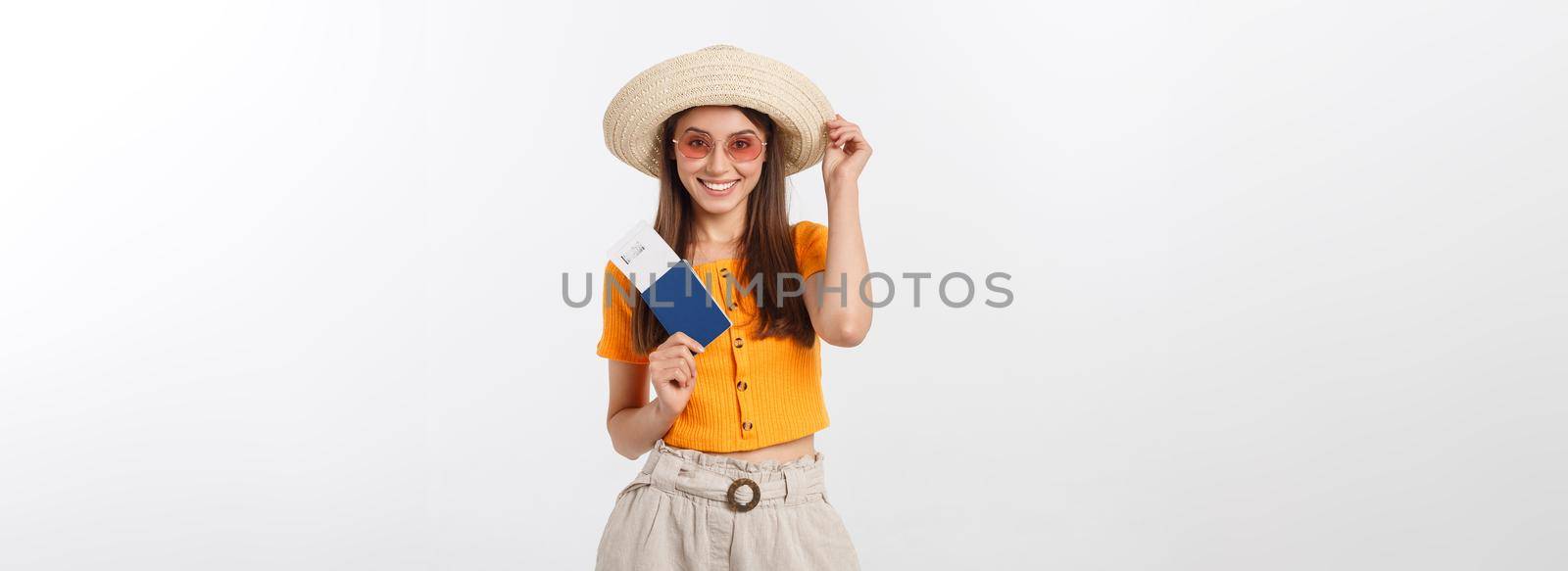 Portrait of happy tourist woman holding passport on holiday on white background