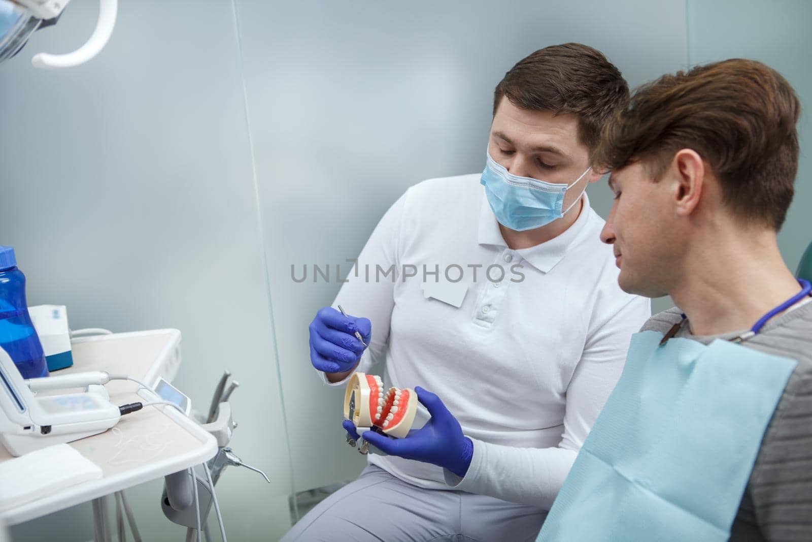 Male patient getting dental treatment by MAD_Production