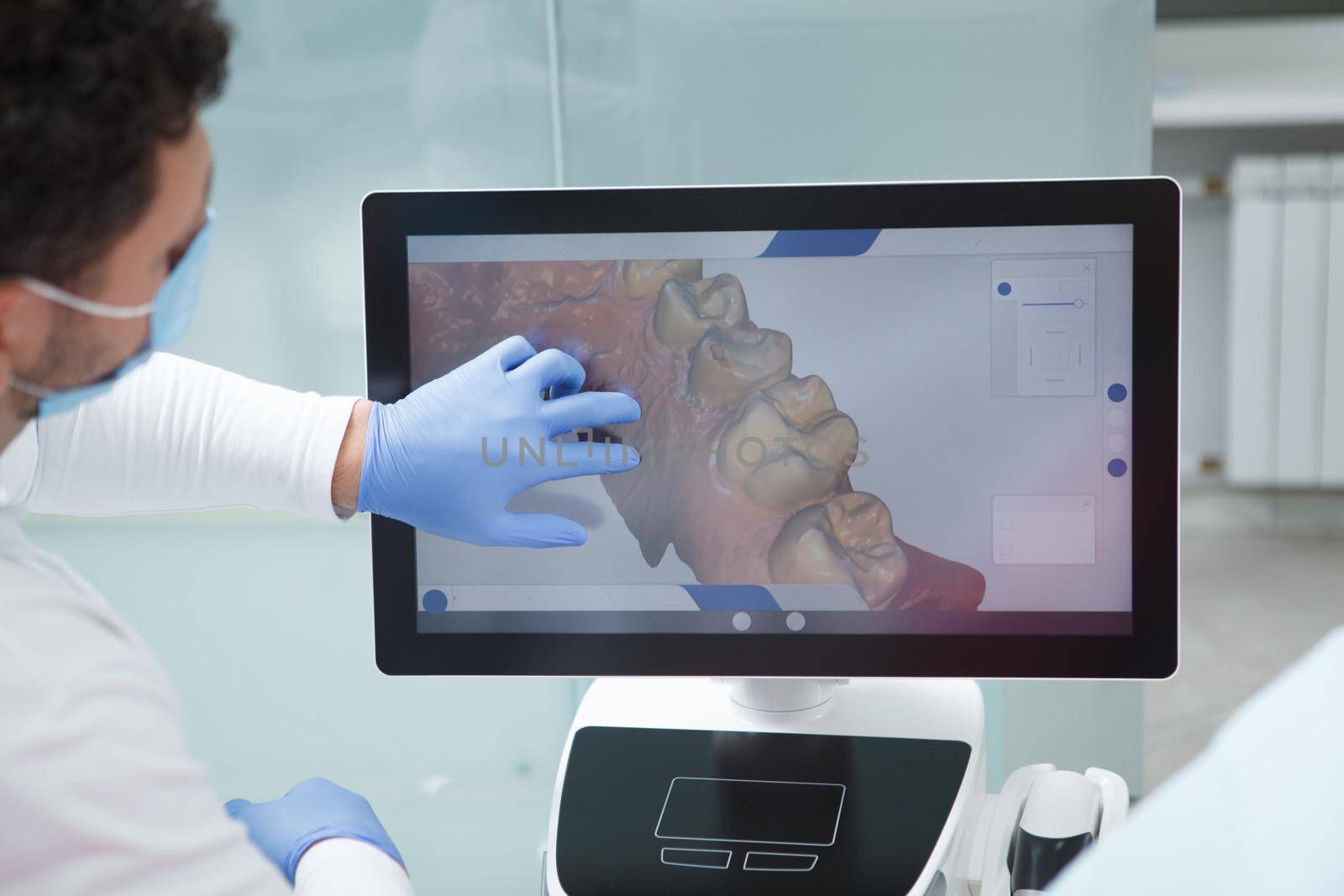 Dentist using dental scanner on patient by MAD_Production