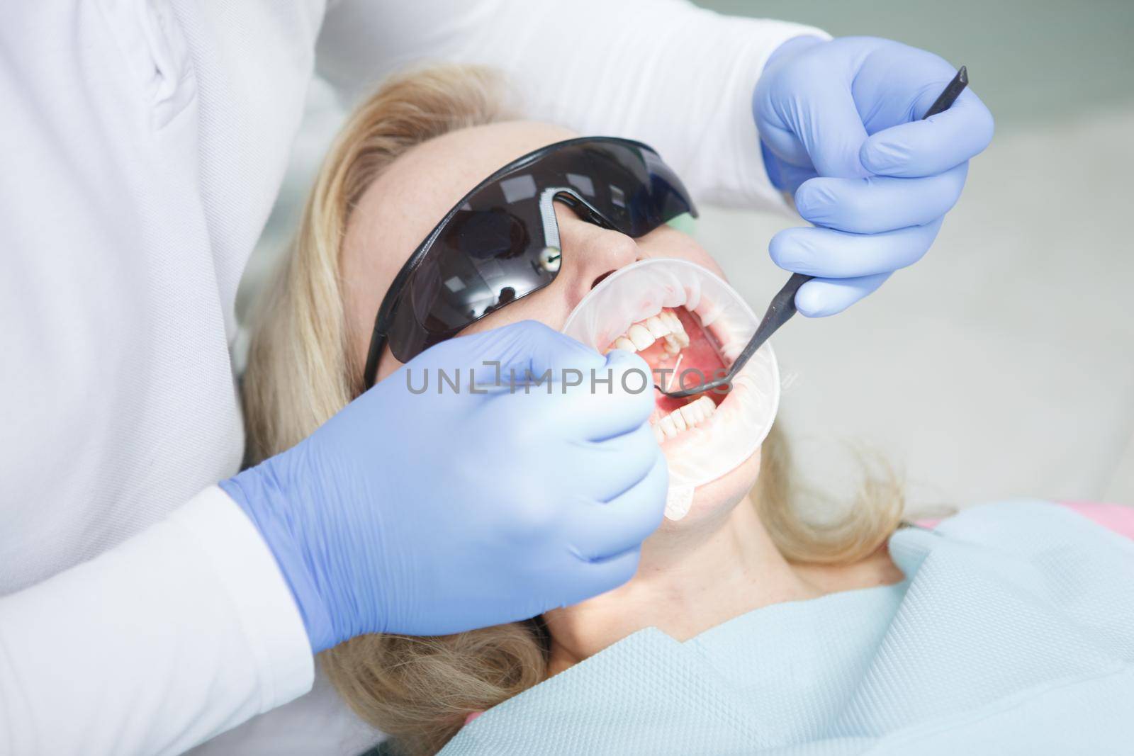 Mature woman at dental clinic by MAD_Production