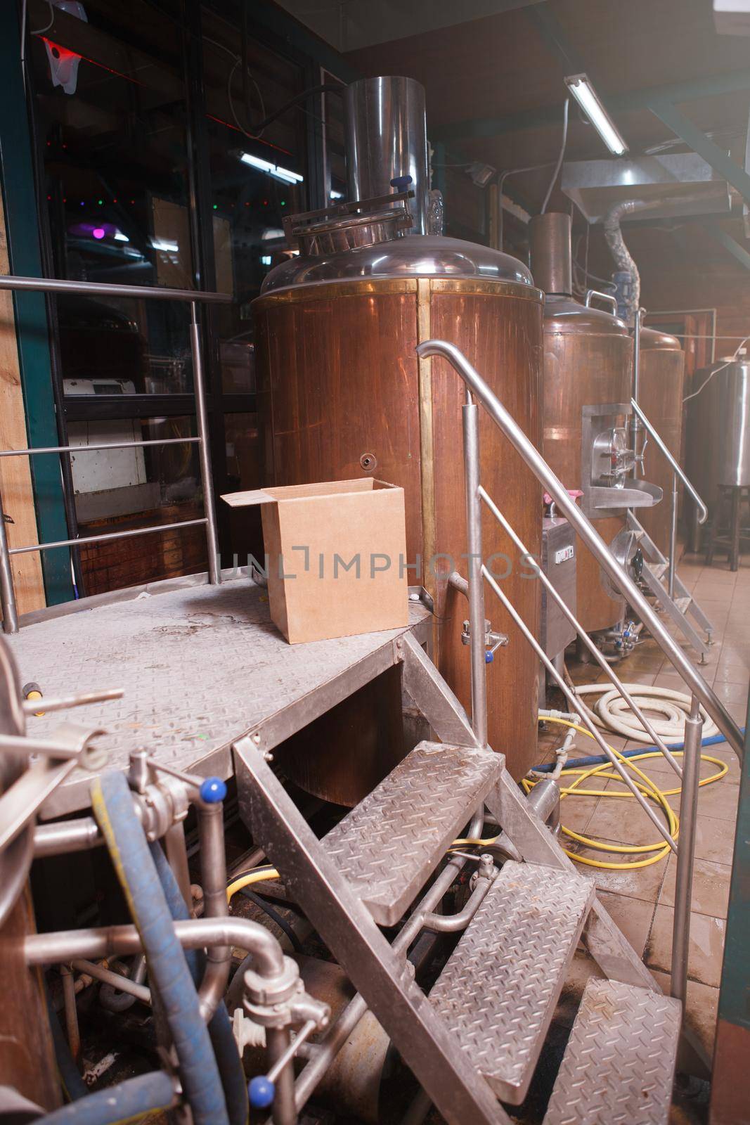 Vertical shot of metal beer tanks at small microbrewery